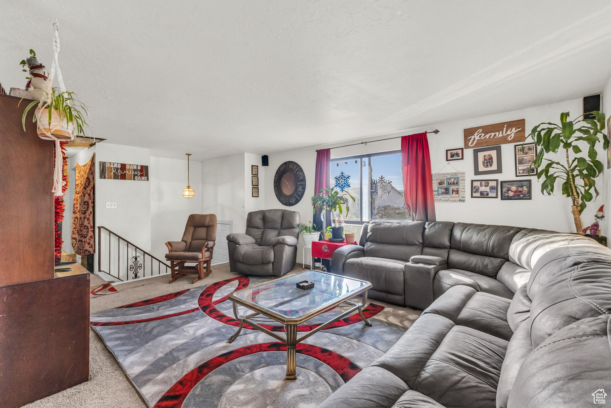 Carpeted living room with a textured ceiling