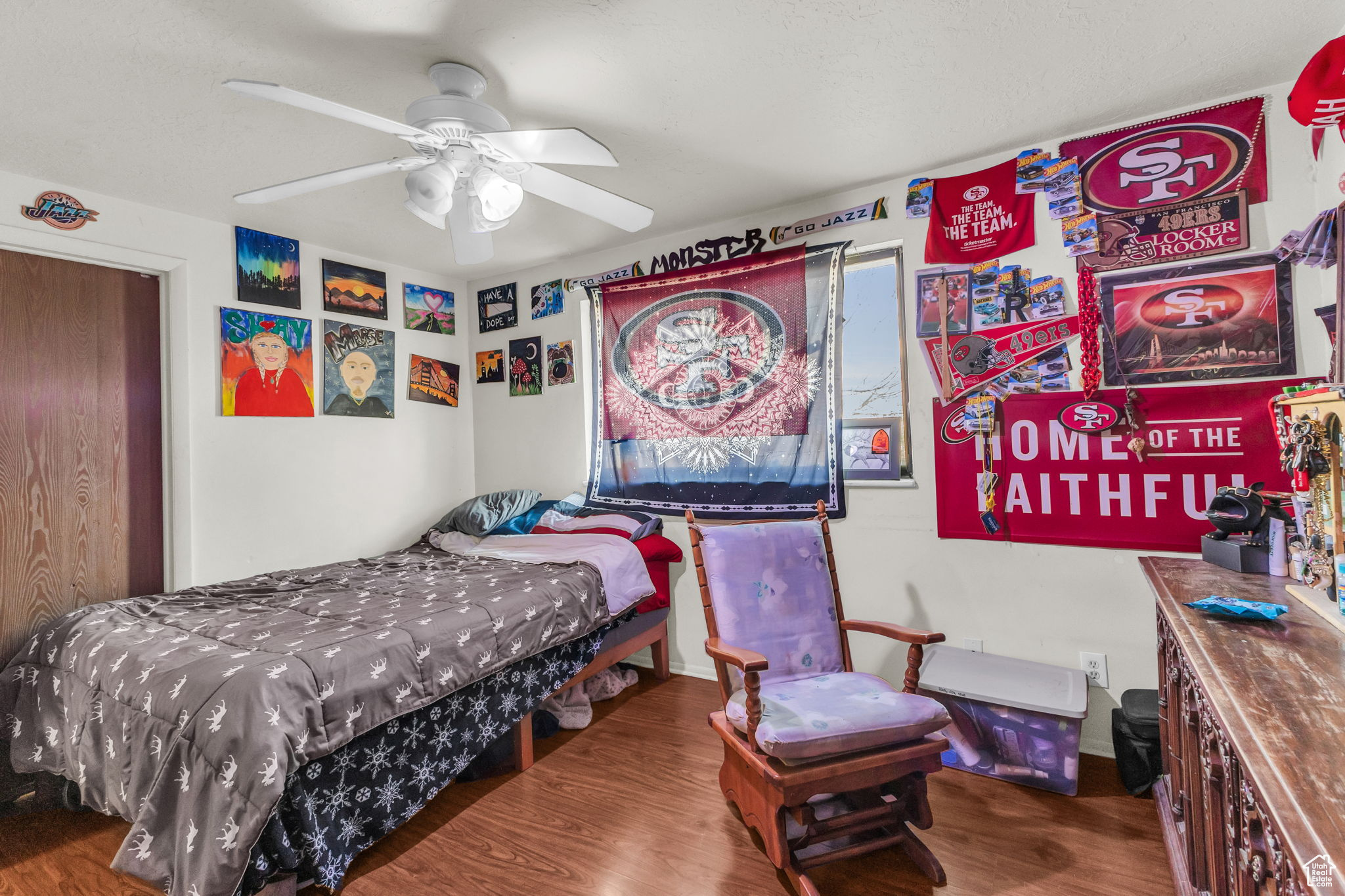 Bedroom featuring wood-type flooring and ceiling fan