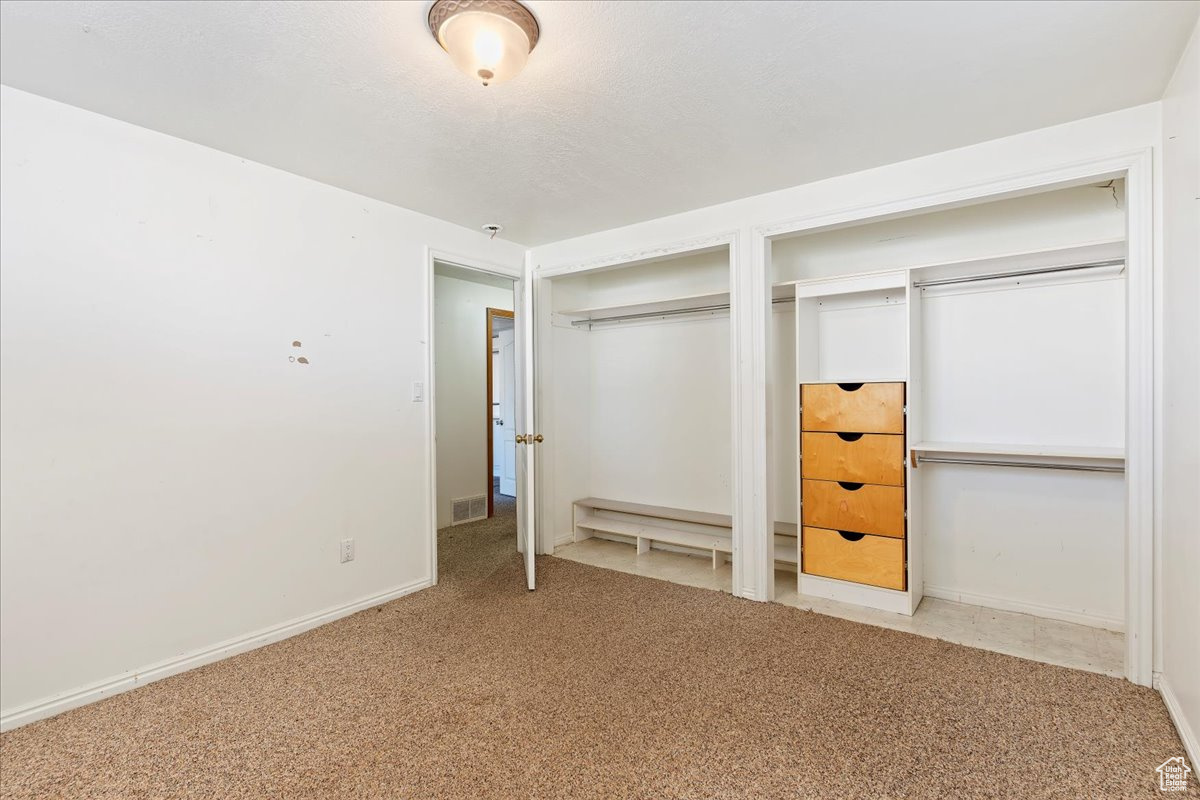 Unfurnished bedroom featuring carpet floors