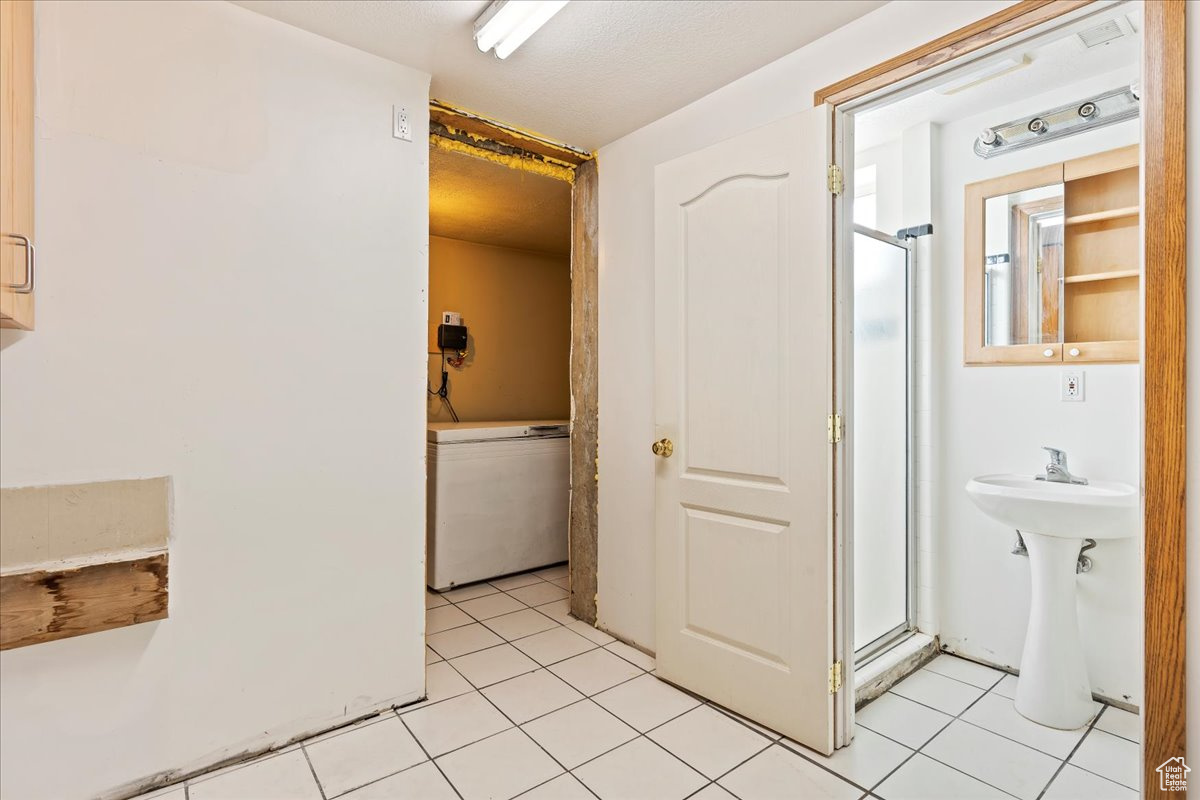 Bathroom with tile patterned floors and walk in shower