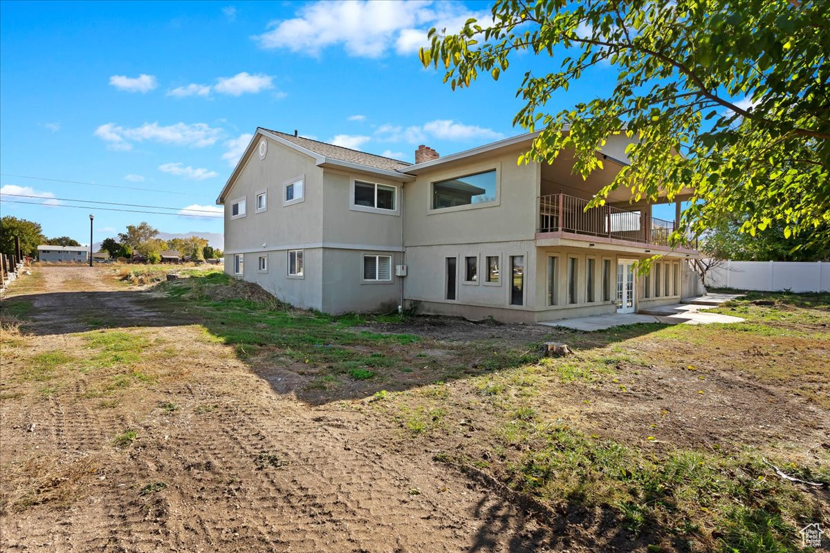 Back of house with a balcony