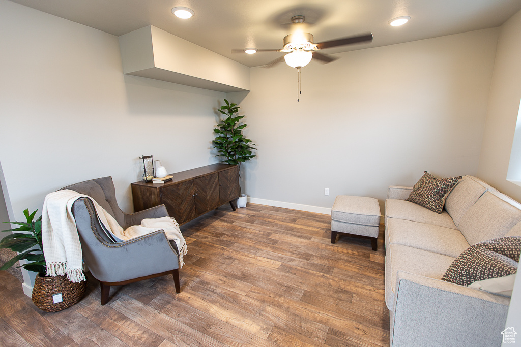 Living room featuring wood-type flooring and ceiling fan