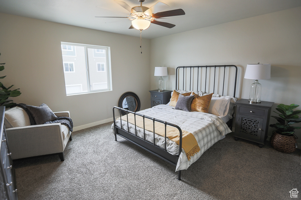 Carpeted bedroom featuring ceiling fan