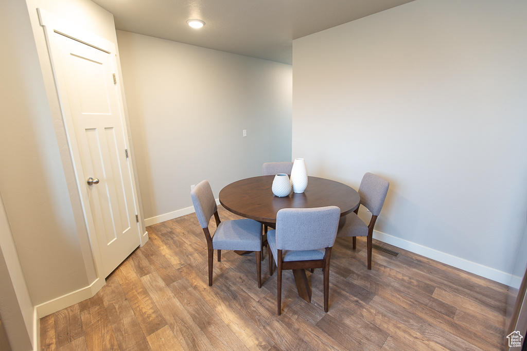 Dining area featuring dark wood-type flooring