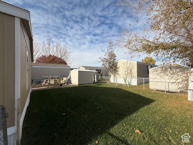 View of yard with a storage shed