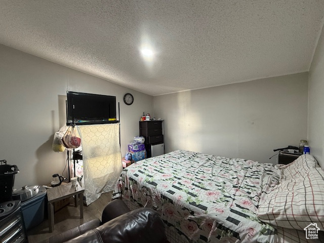 Bedroom featuring hardwood / wood-style floors and a textured ceiling