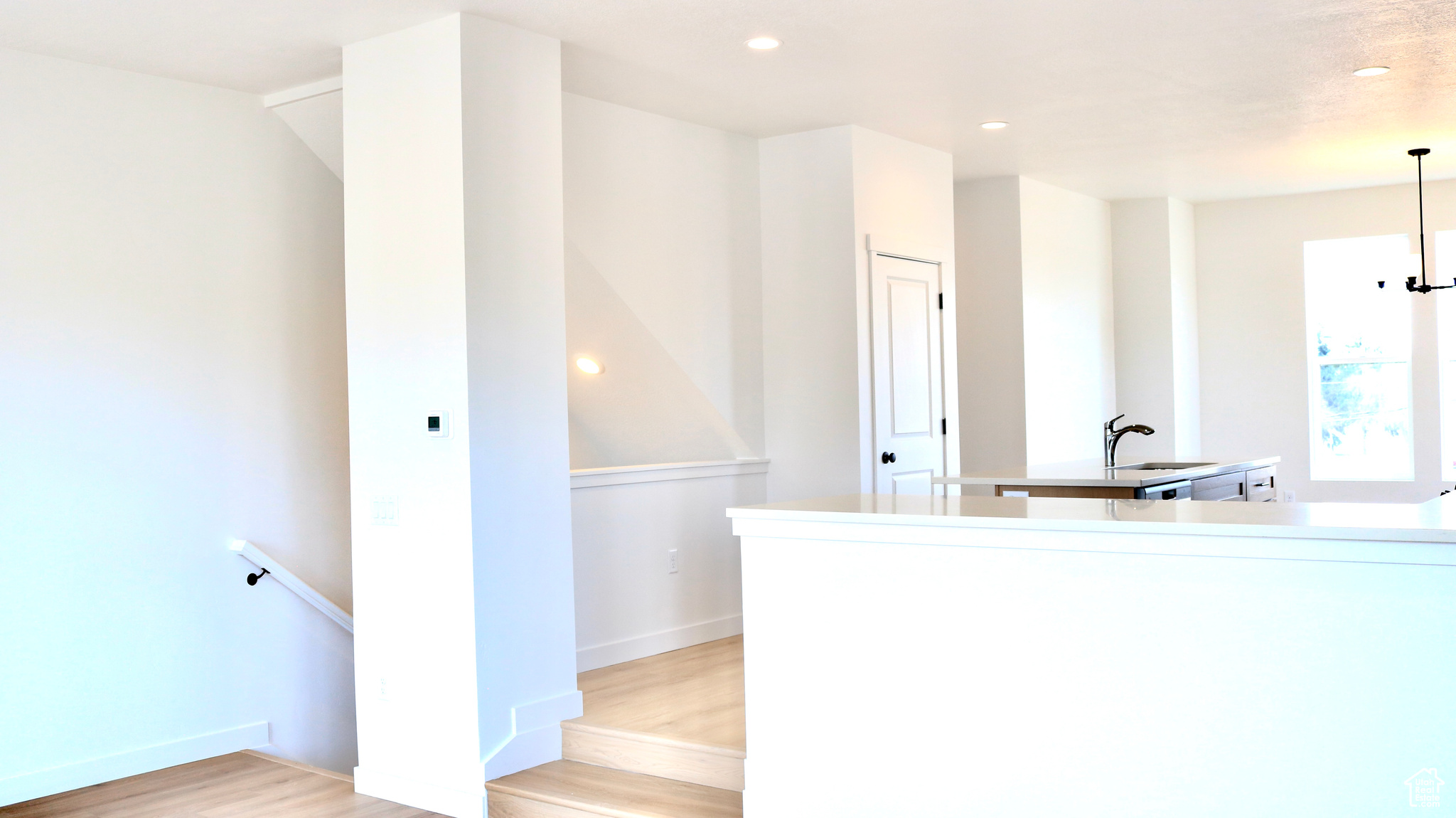 Kitchen with sink and light hardwood / wood-style floors