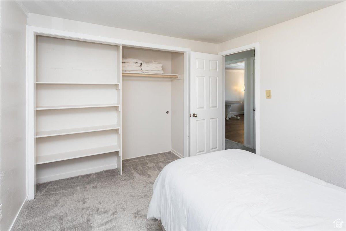 Bedroom with carpet flooring and a closet