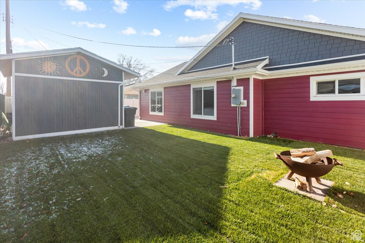 Back of house featuring a yard and workshop