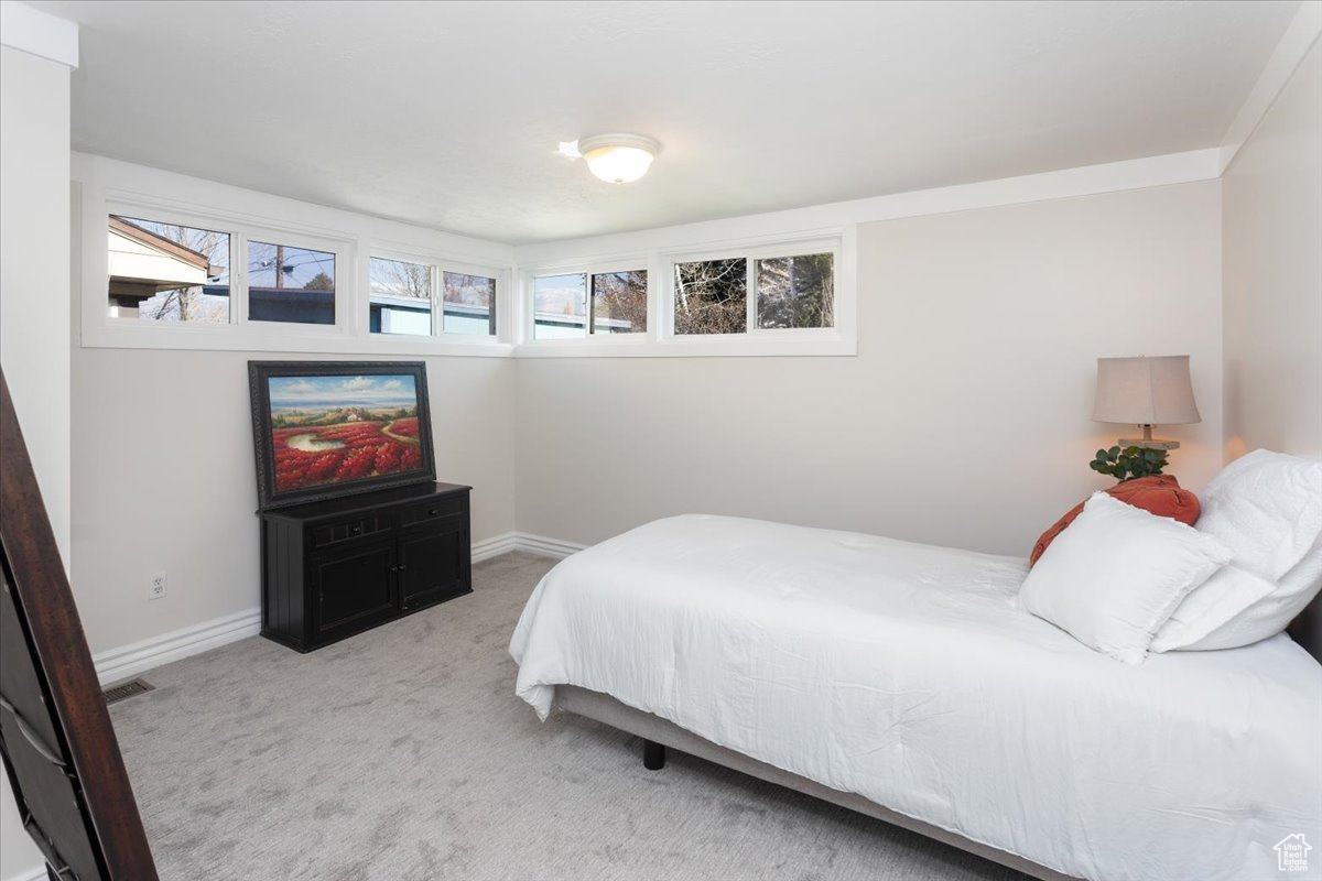 Bedroom featuring light colored carpet