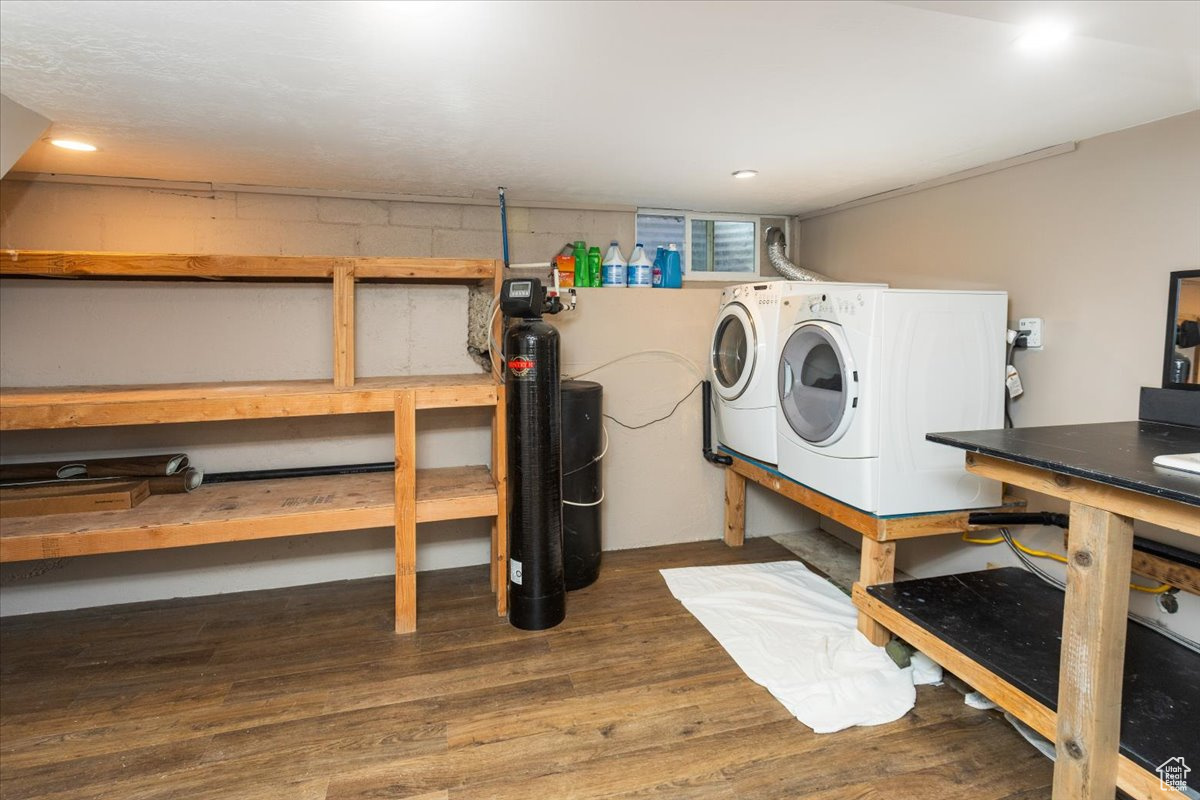 Laundry area dark hardwood / wood-style flooring