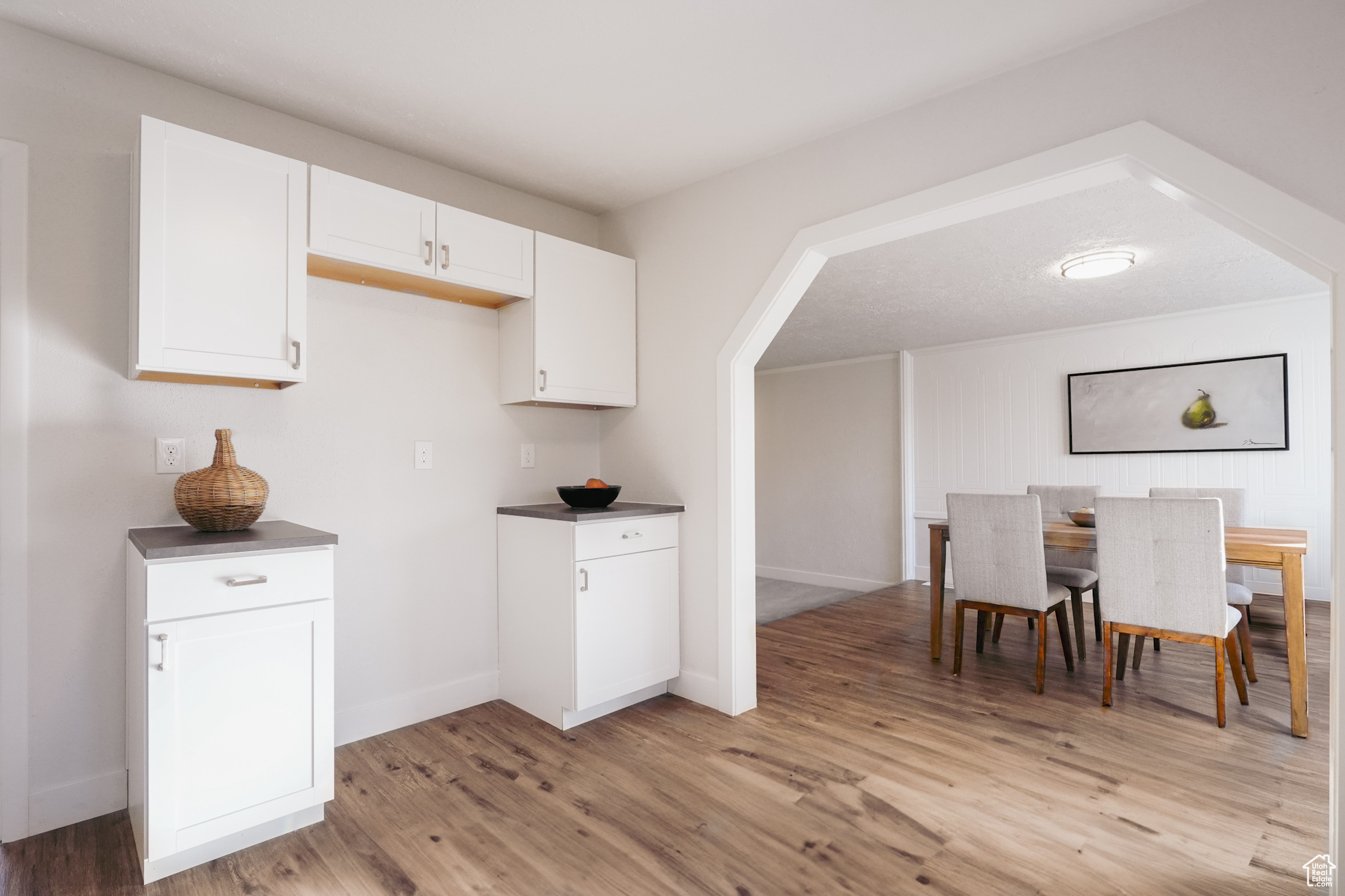 Kitchen featuring white cabinets and light wood-type flooring