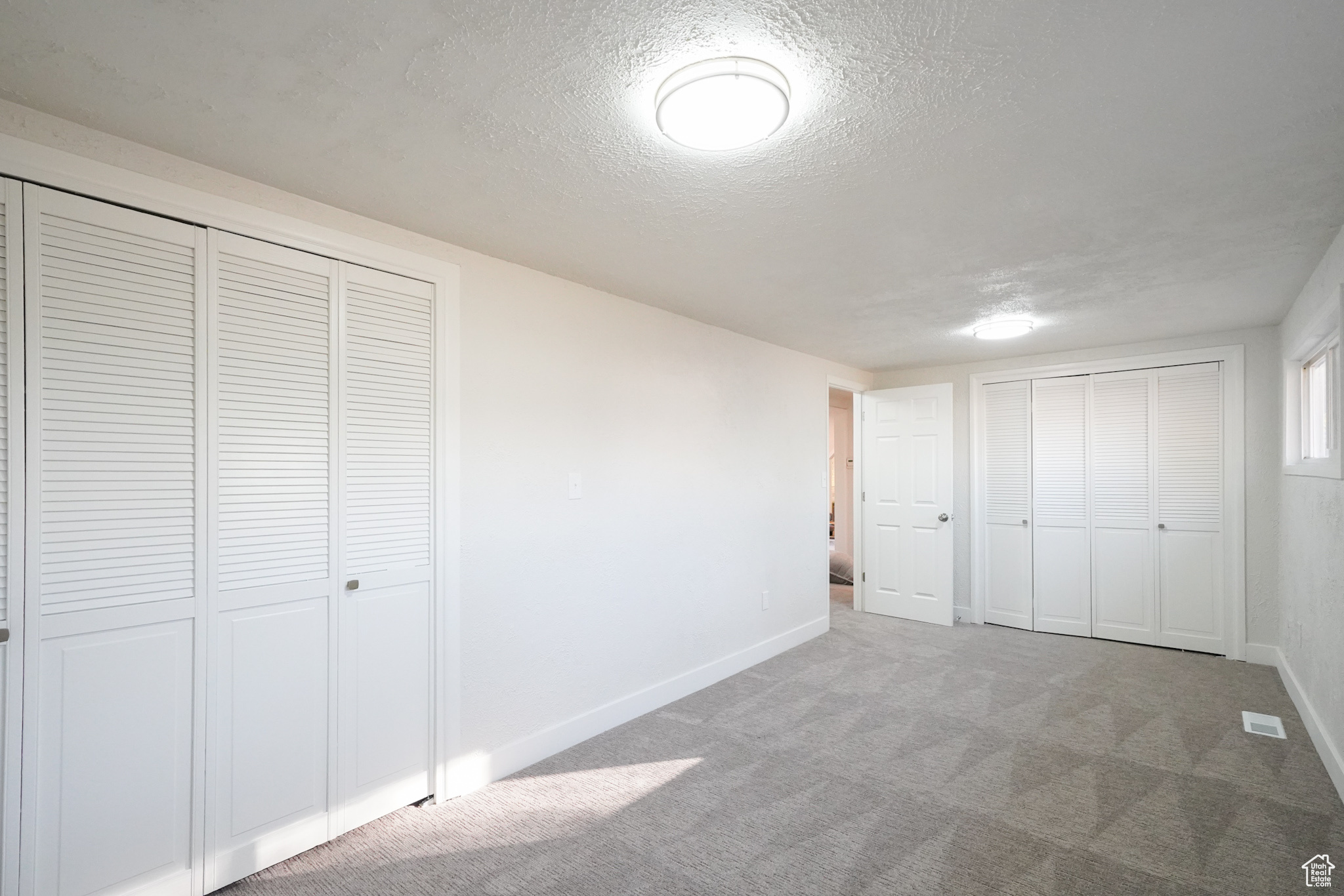 Unfurnished bedroom with carpet flooring and a textured ceiling