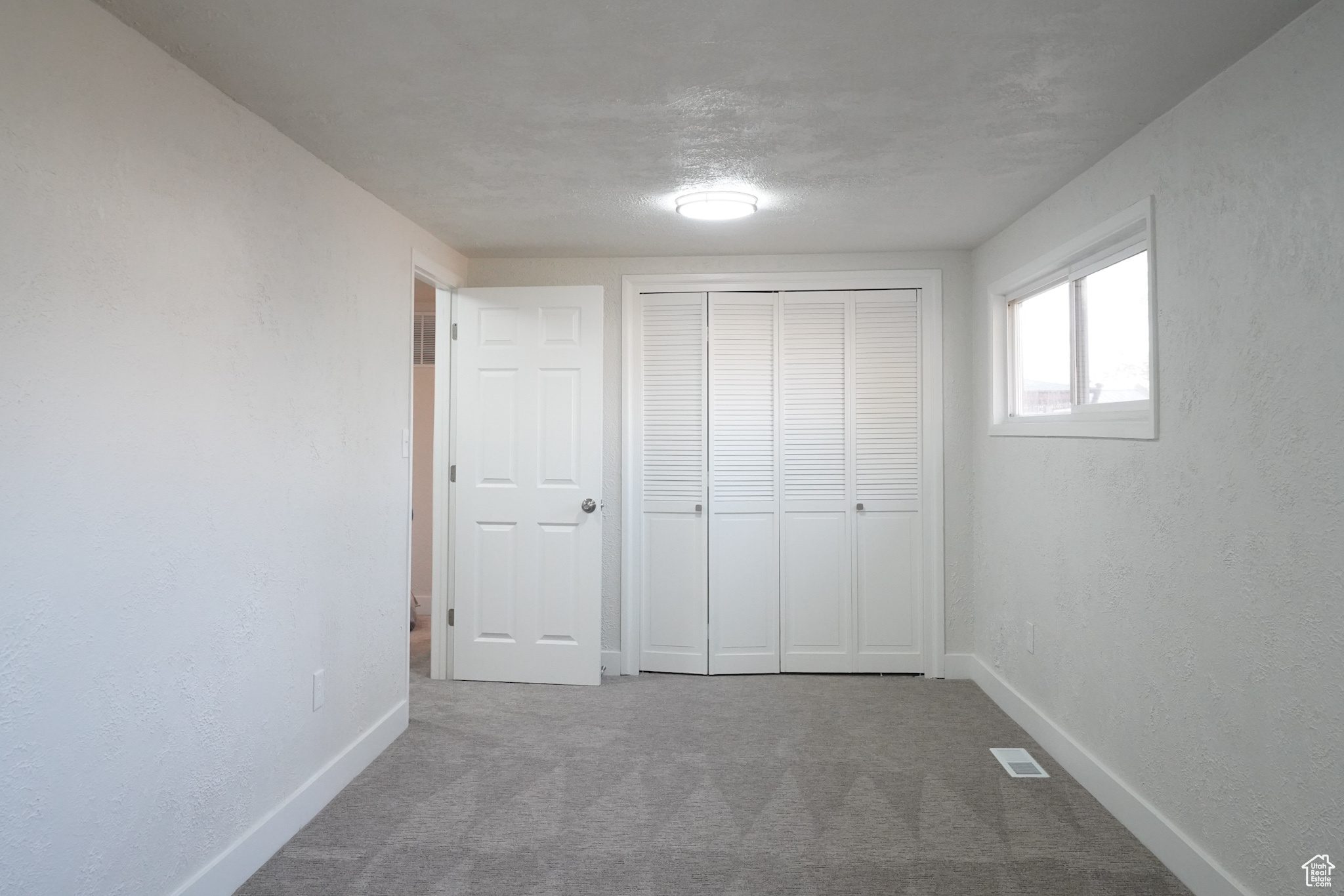 Unfurnished bedroom featuring a closet and carpet floors