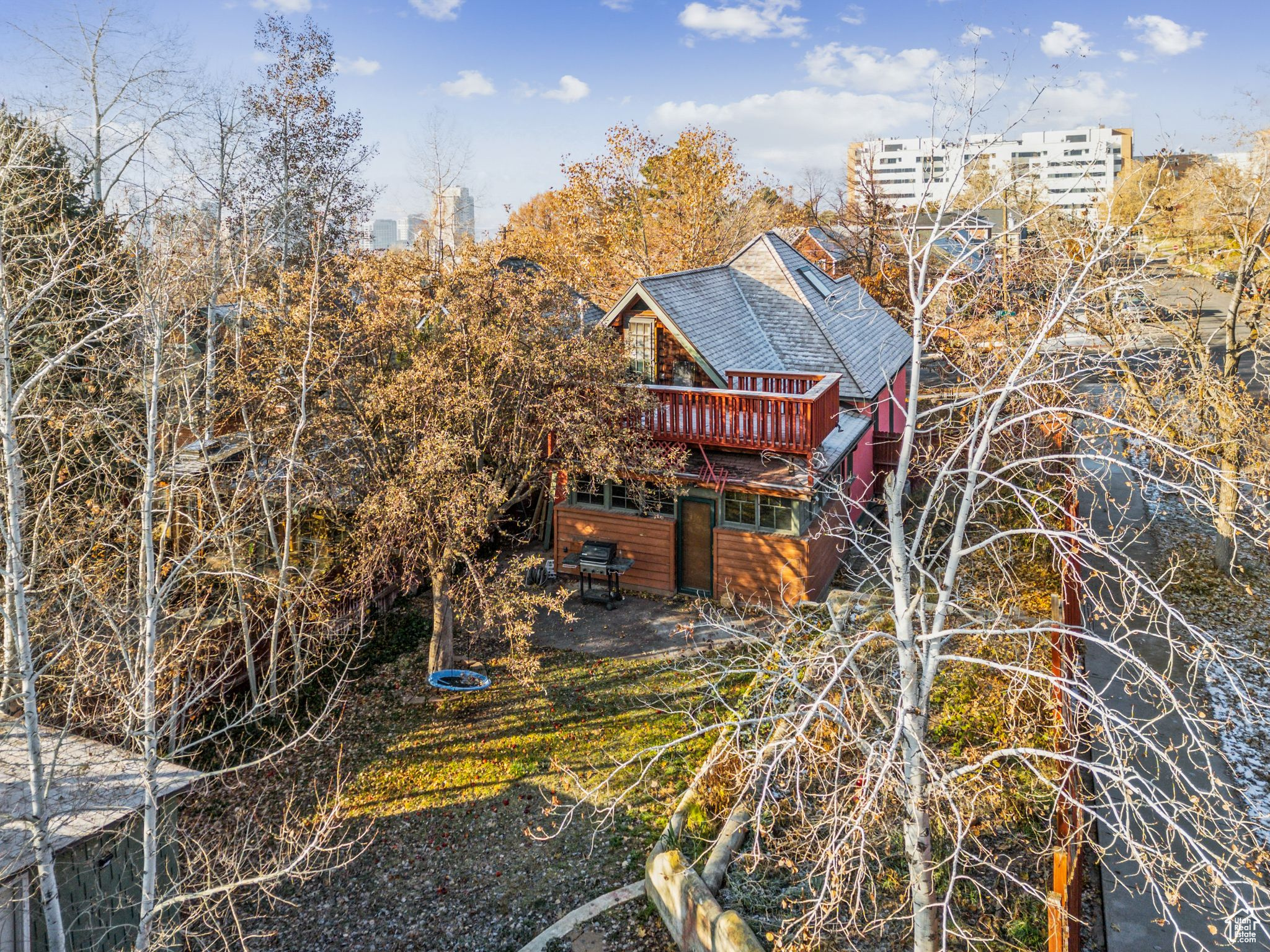 Rear view of property with a deck, a yard, and a patio