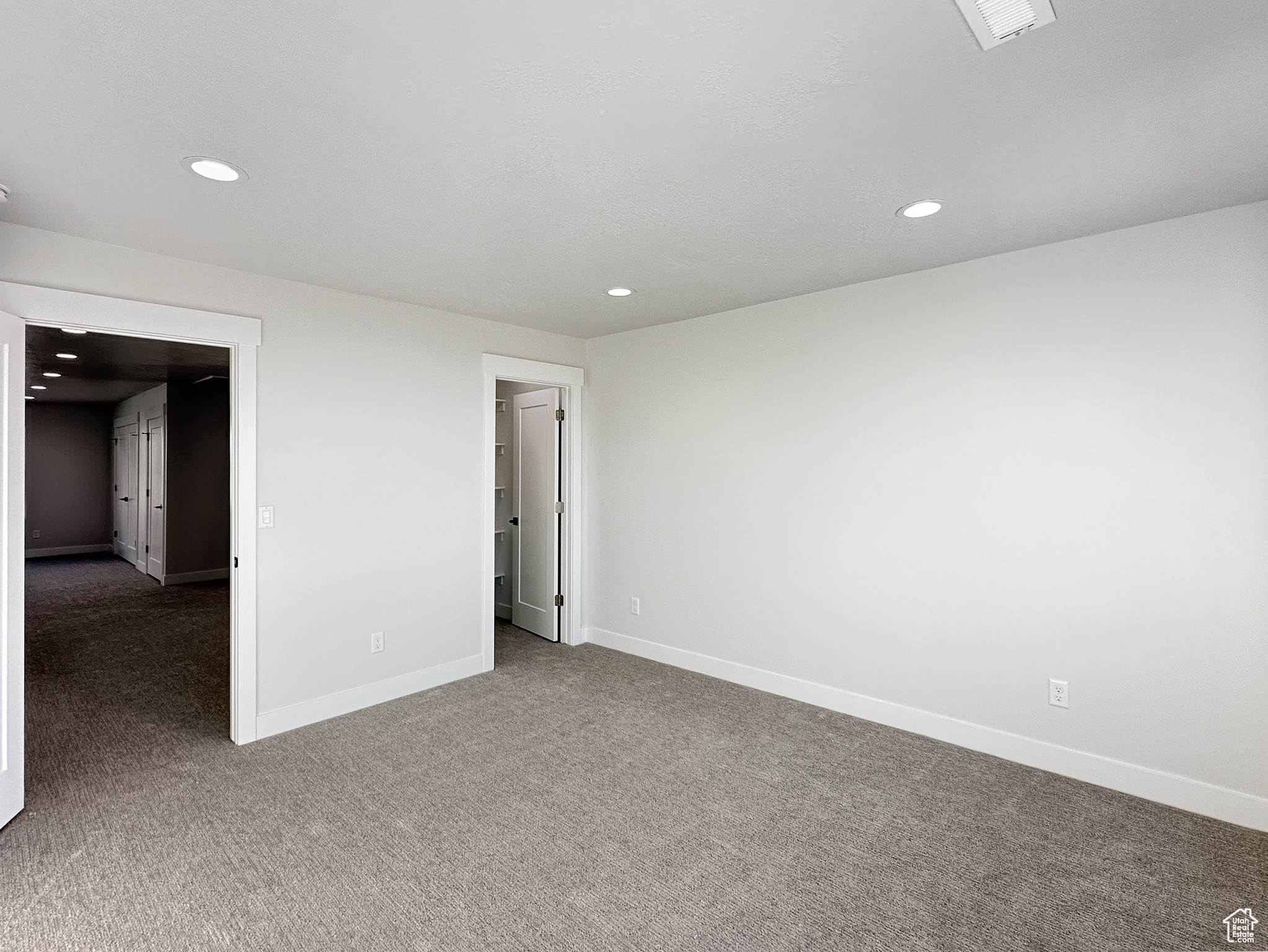 Unfurnished bedroom featuring dark colored carpet