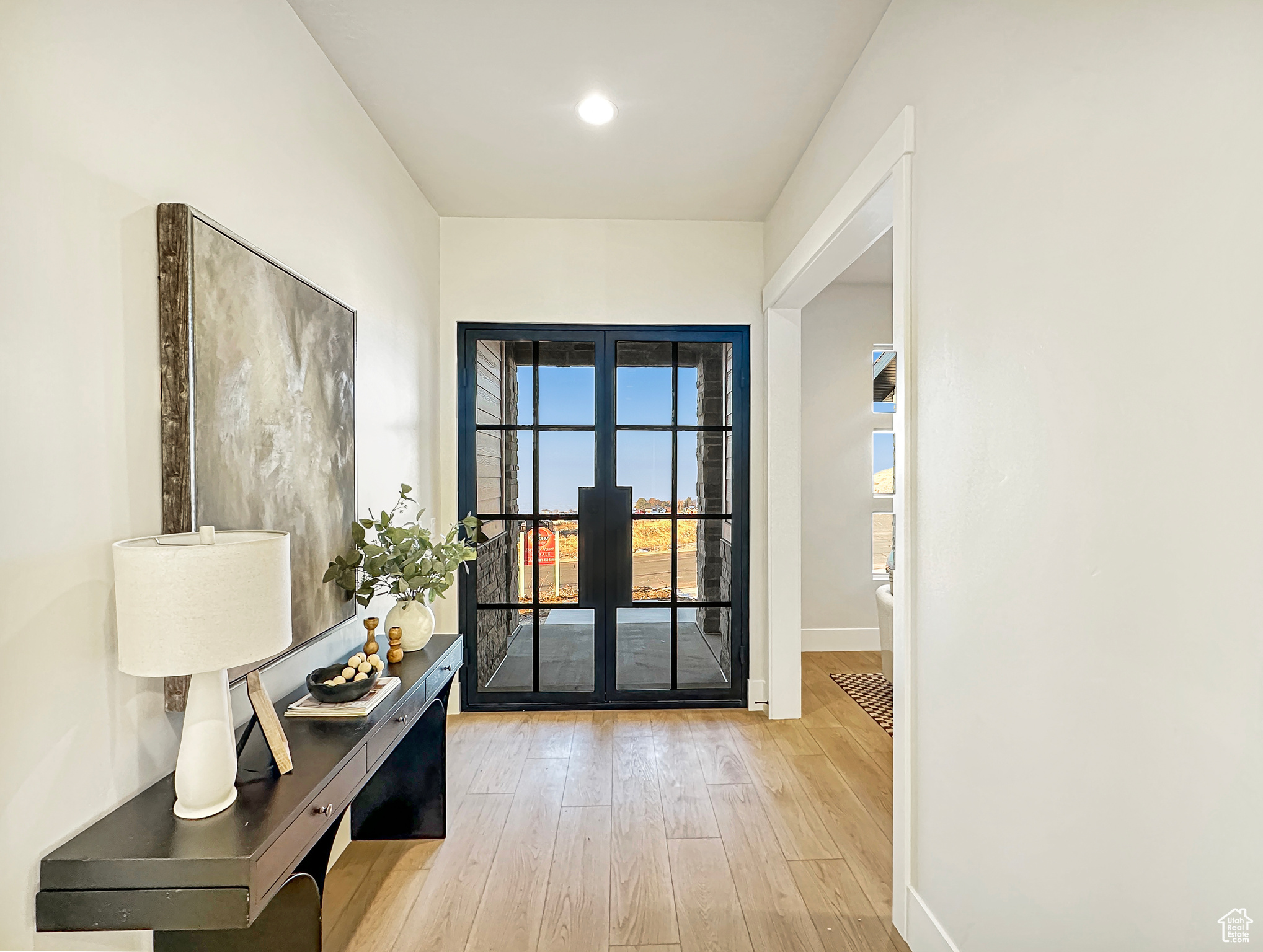 Entryway with french doors and light wood-type flooring