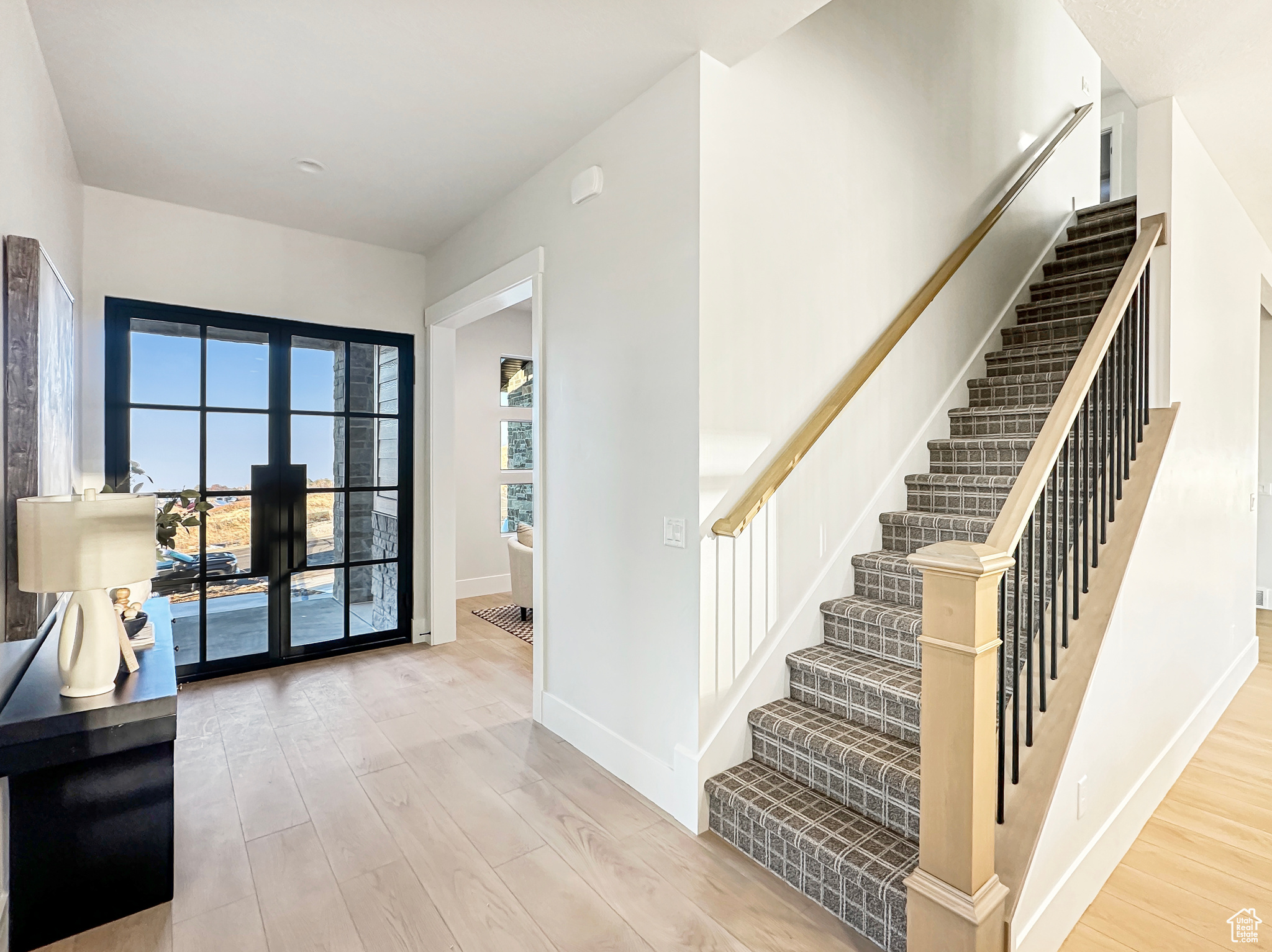 Entrance foyer with light hardwood / wood-style floors and french doors