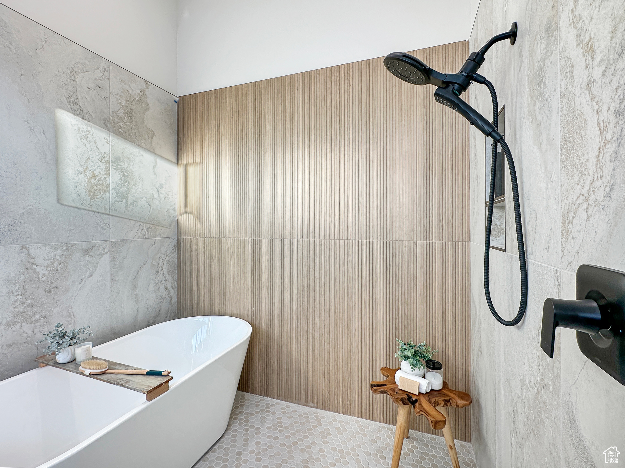 Bathroom featuring a tub and tile walls