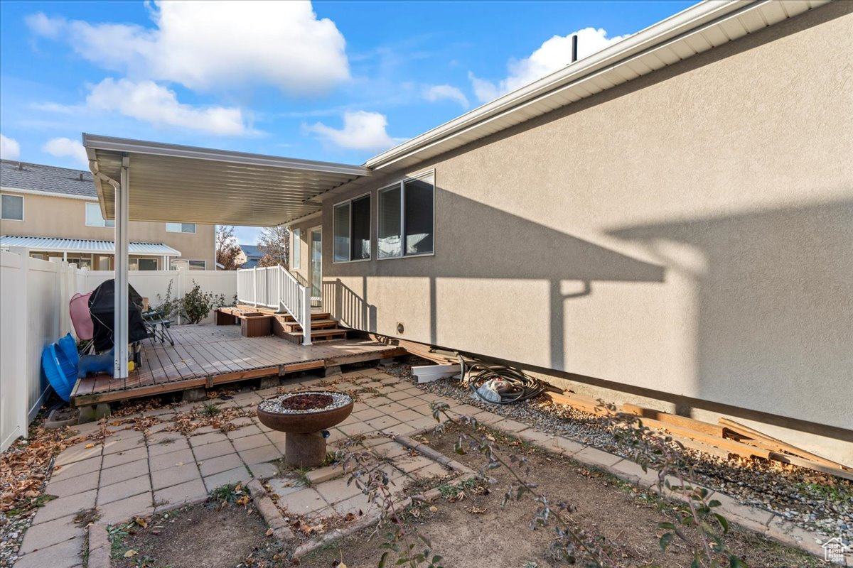 View of patio / terrace featuring a grill, an outdoor fire pit, and a wooden deck