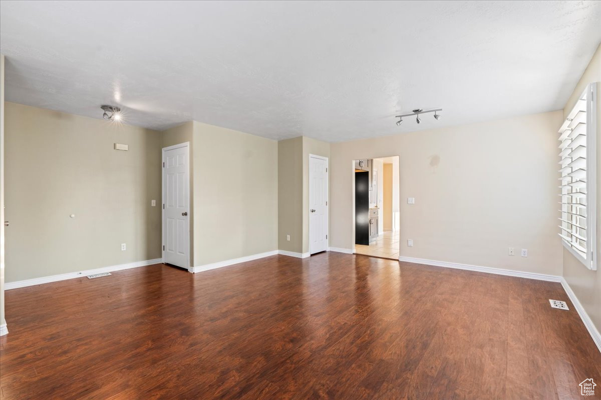 Unfurnished room featuring dark wood-type flooring