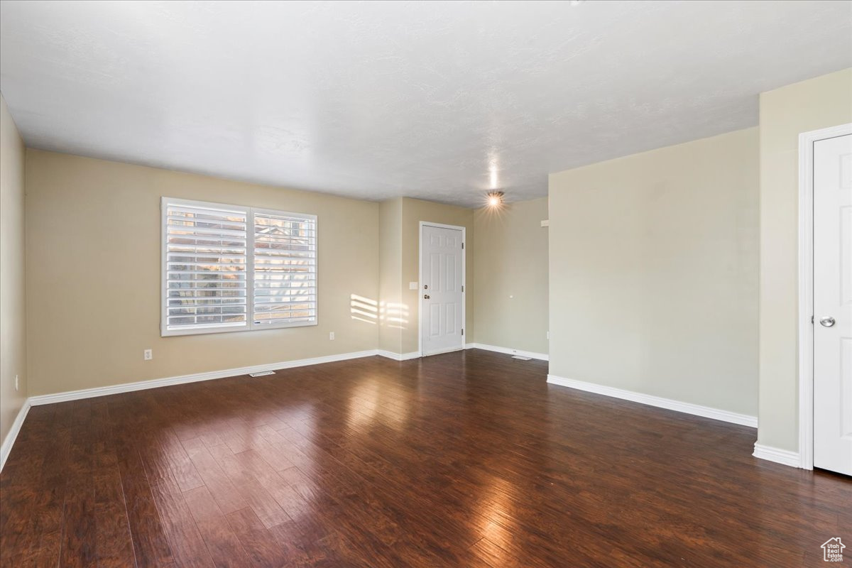 Unfurnished room with dark hardwood / wood-style flooring