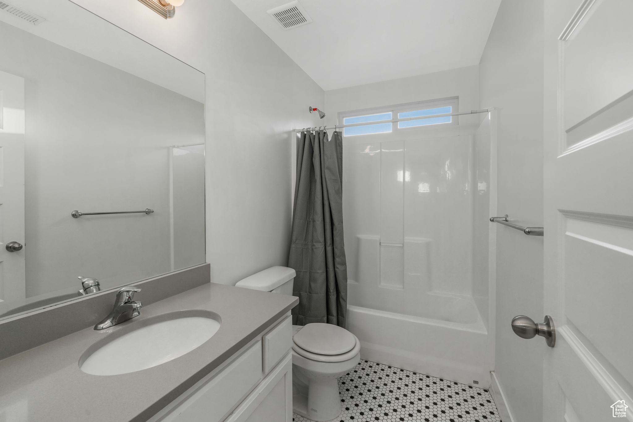 Full bathroom featuring shower / tub combo, vanity, and toilet