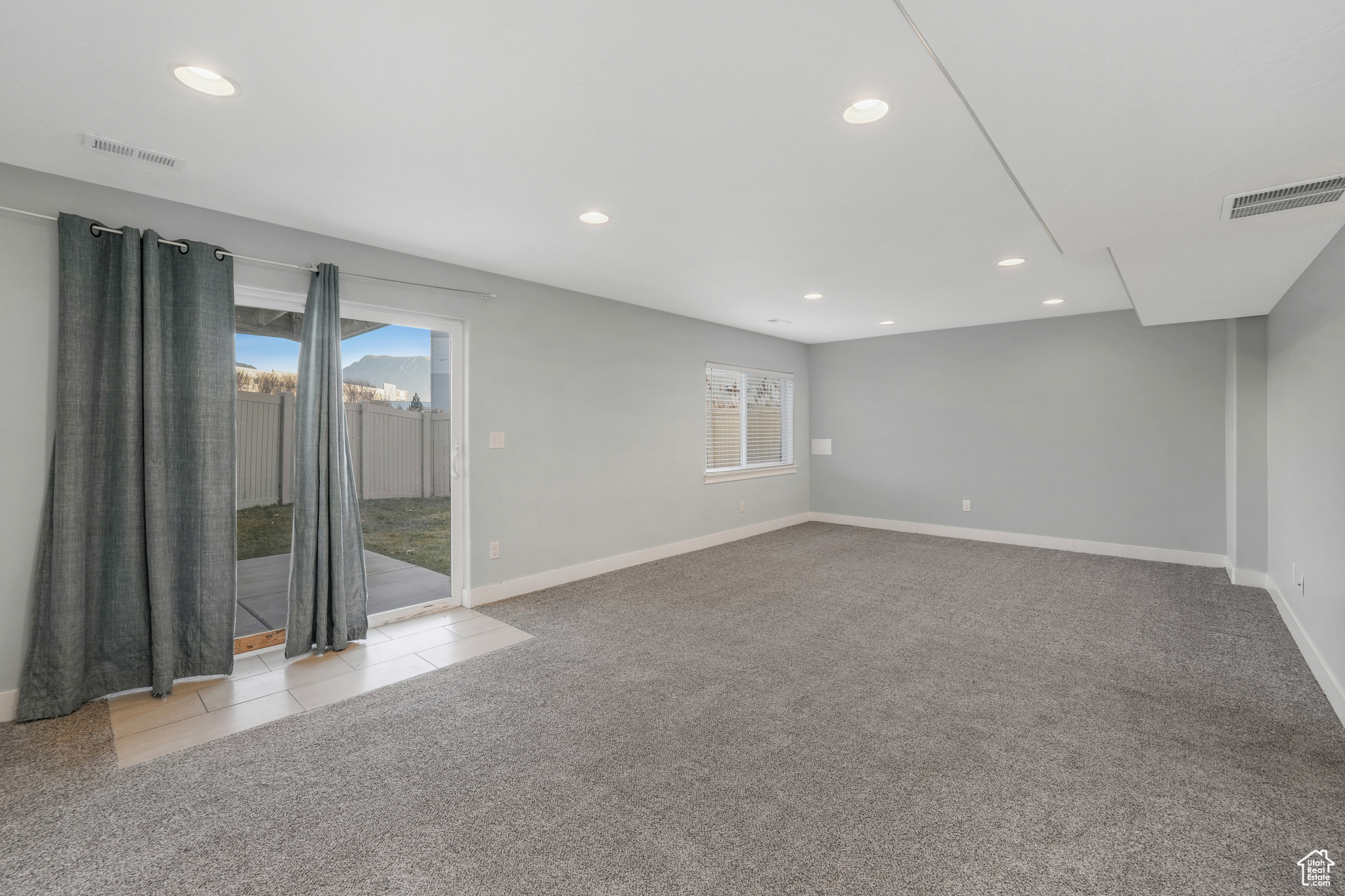 Unfurnished room with light colored carpet