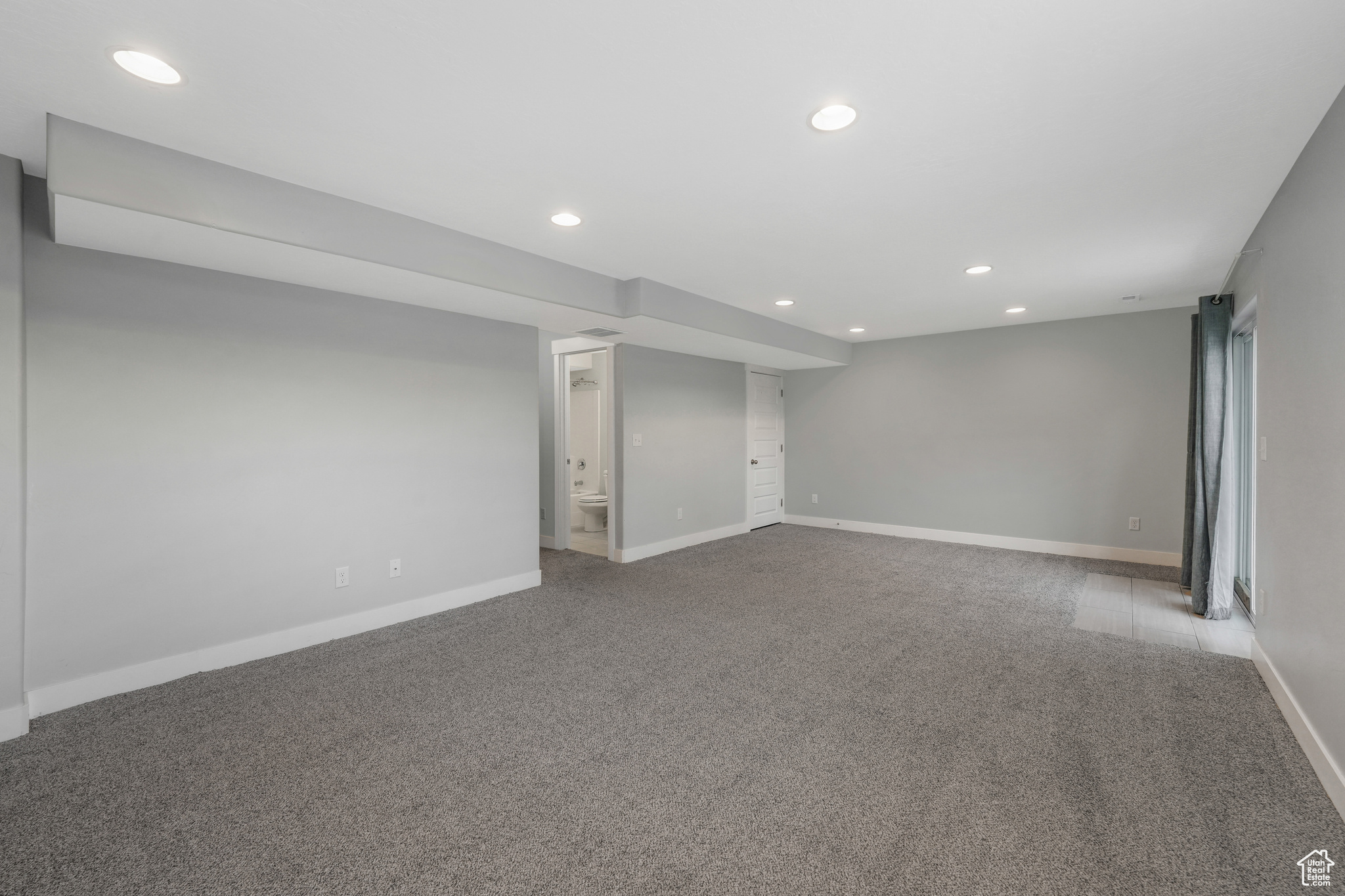 Basement featuring light carpet