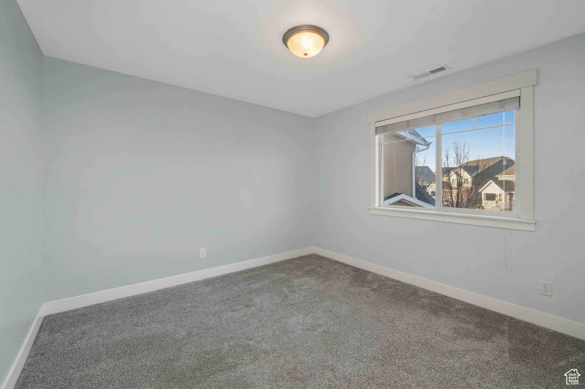 Spare room featuring carpet