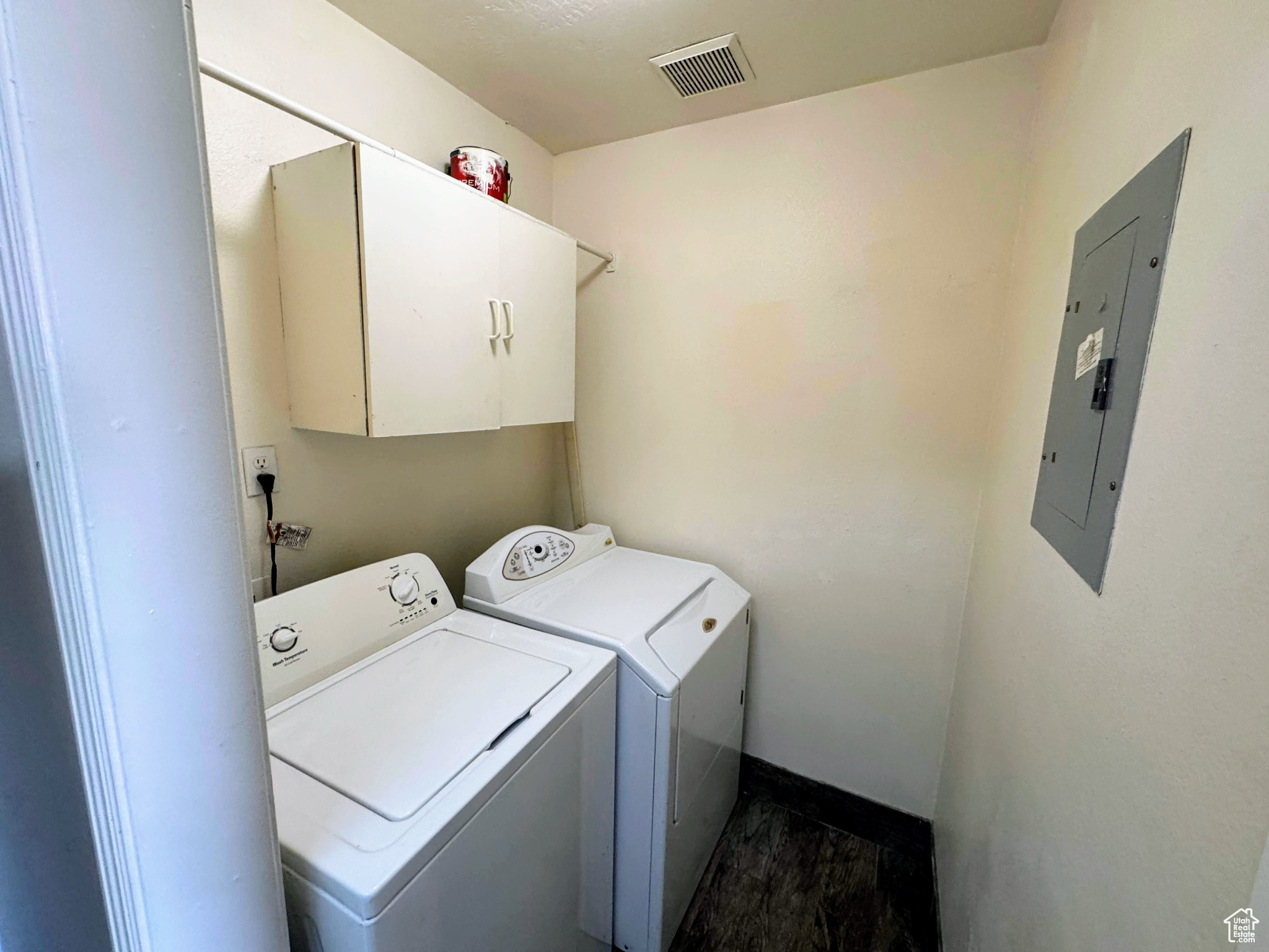 Laundry room with cabinets, electric panel, and separate washer and dryer