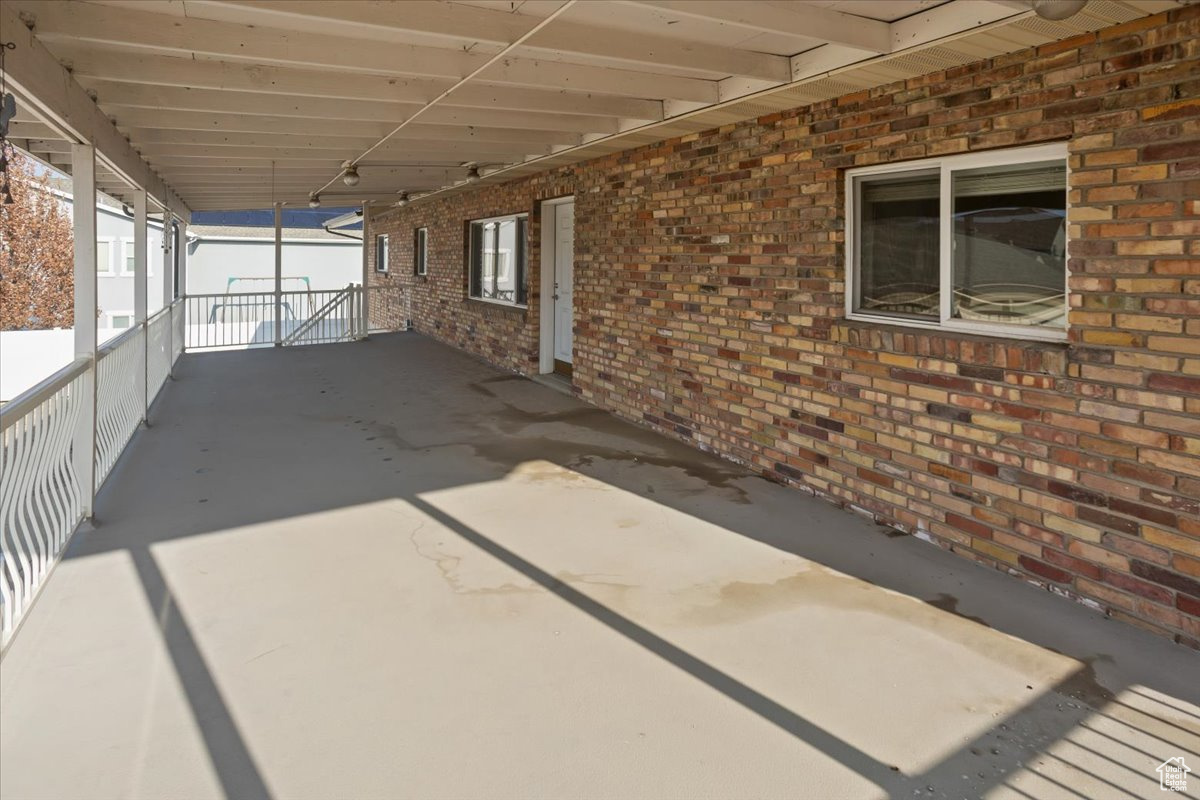 Huge covered patio off of the main level with steps to the lower level and yard.