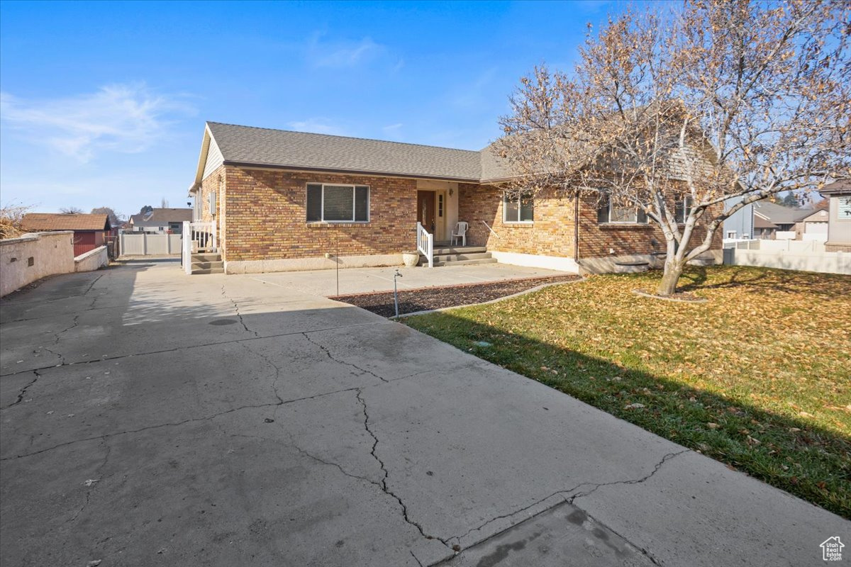 Front of home with large grassy front yard