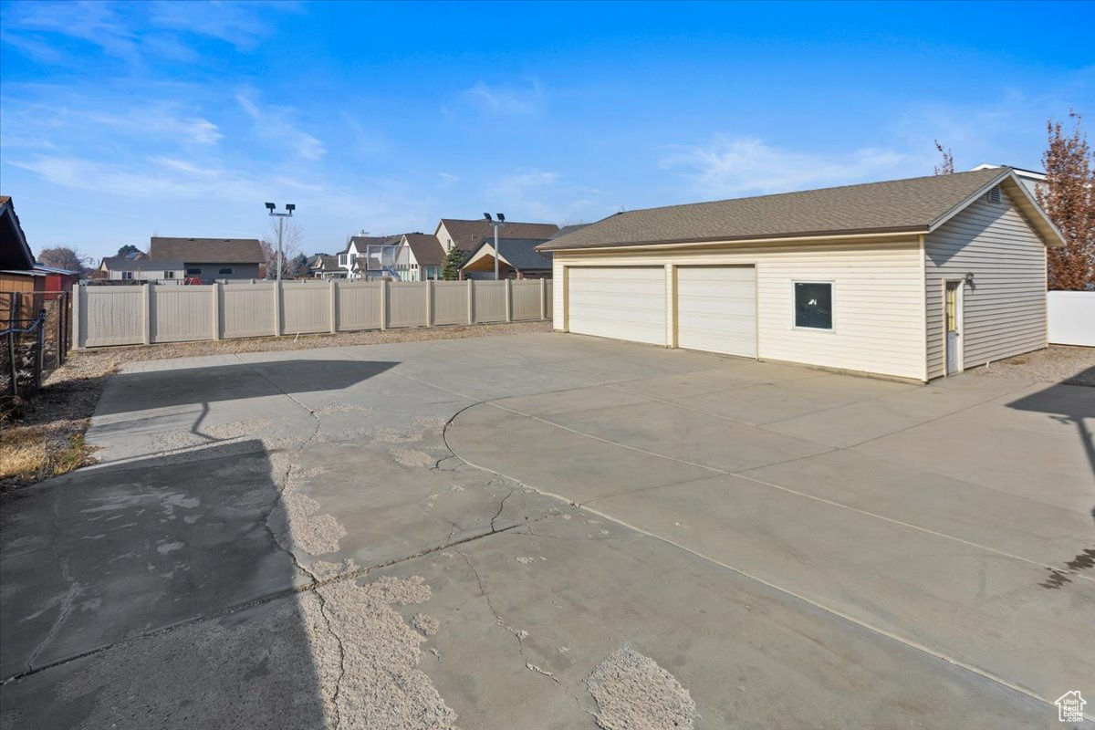 Exterior space featuring a garage and lots of room for parking