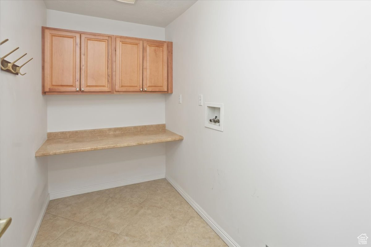 Laundry area with cabinets and hookup for a washing machine