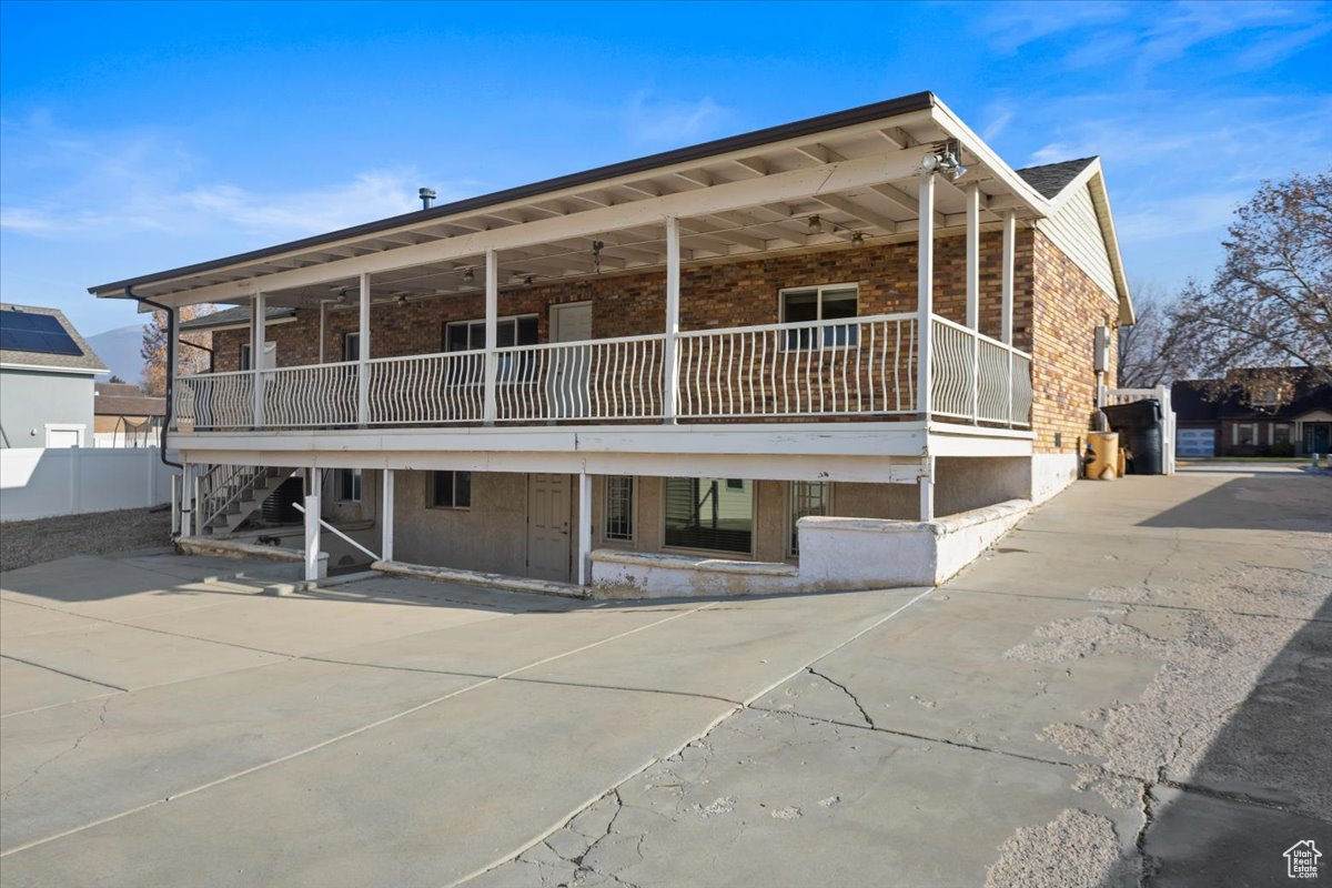 Back of house showing upper and lower patio areas