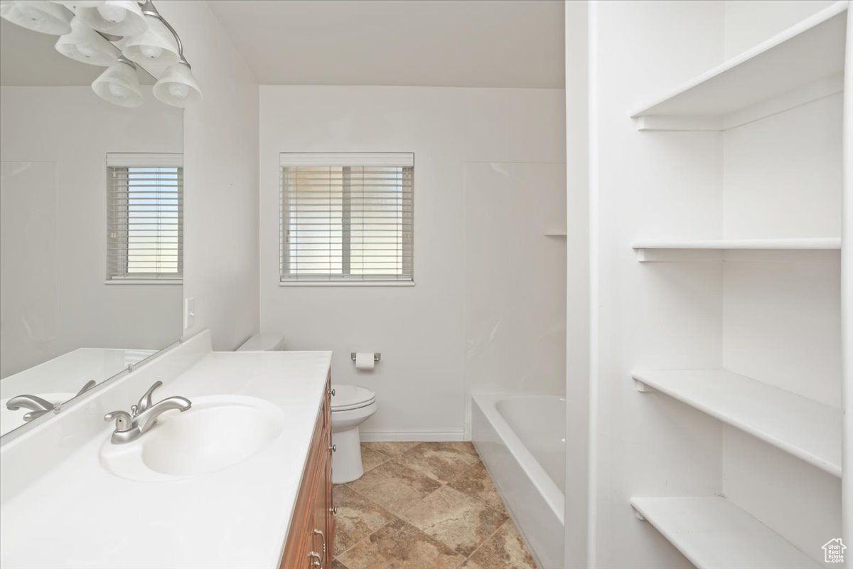 Bathroom with vanity and toilet on main level