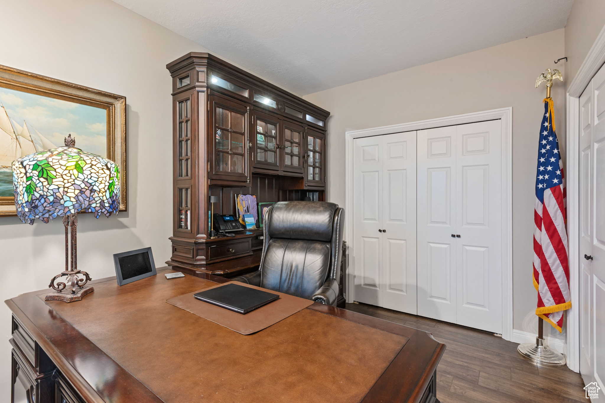 Office area with dark hardwood / wood-style floors