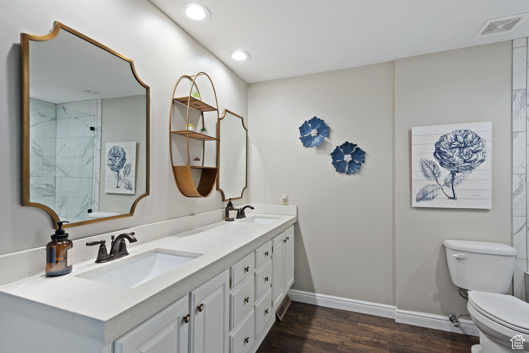 Bathroom featuring wood-type flooring, vanity, and toilet