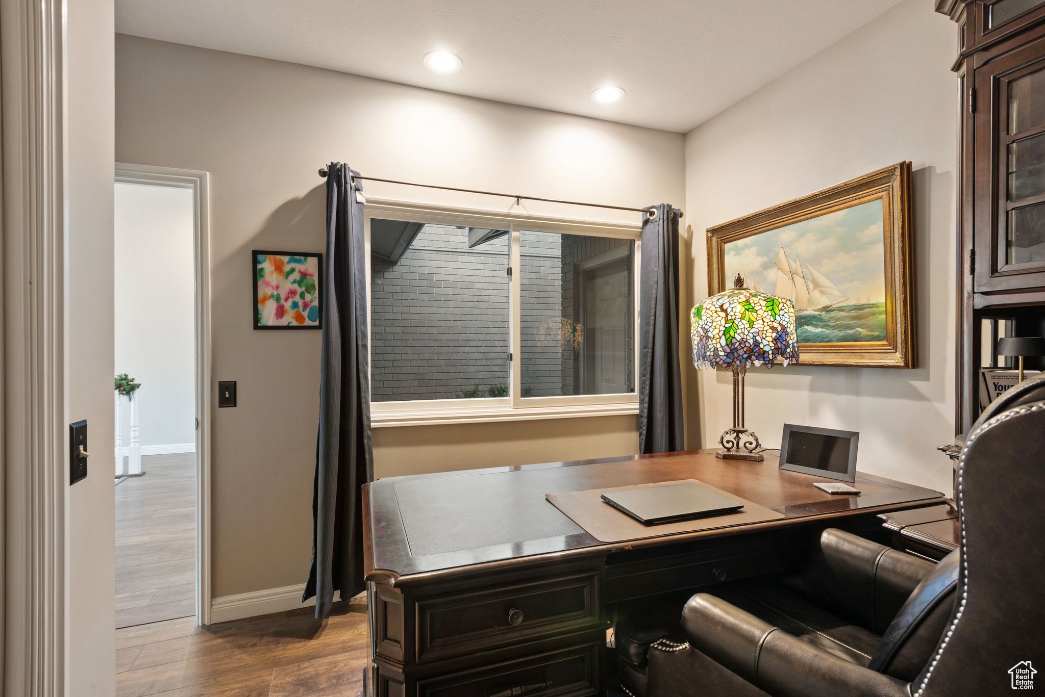 Office area with light hardwood / wood-style flooring