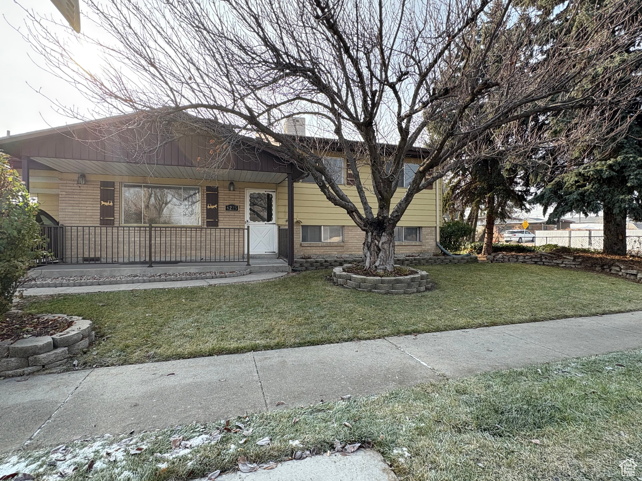 View of front of home with a porch and a front lawn