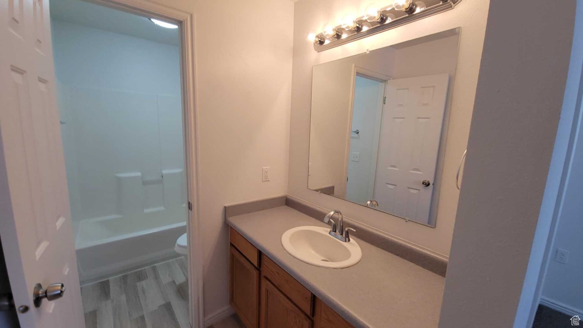 Full bathroom with shower / tub combination, vanity, and toilet