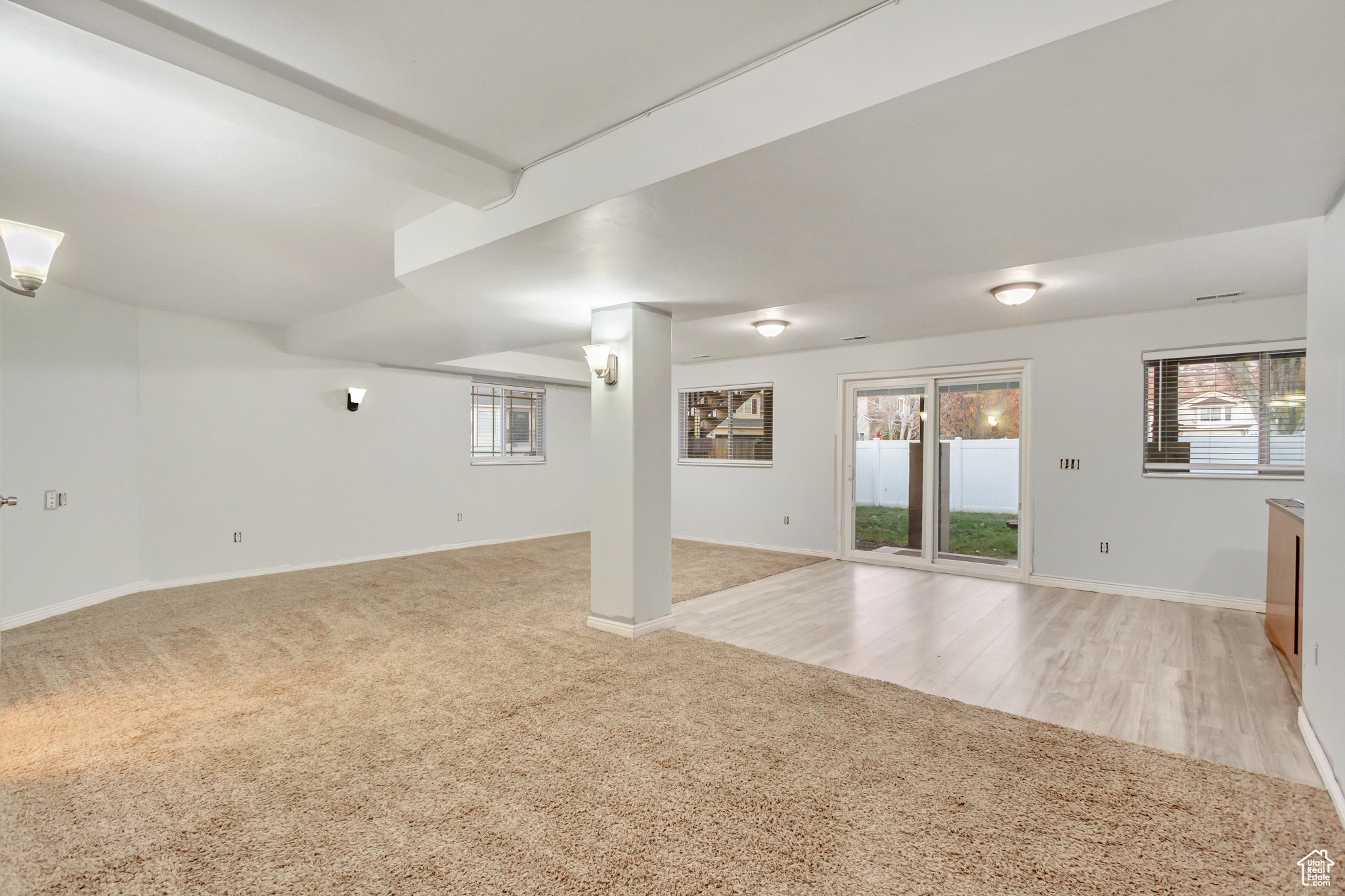 Basement featuring light hardwood / wood-style floors and a wealth of natural light