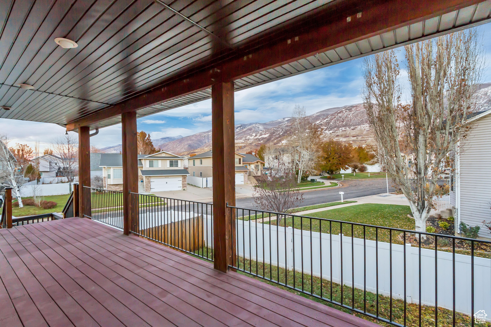 Wooden deck with a lawn and a mountain view