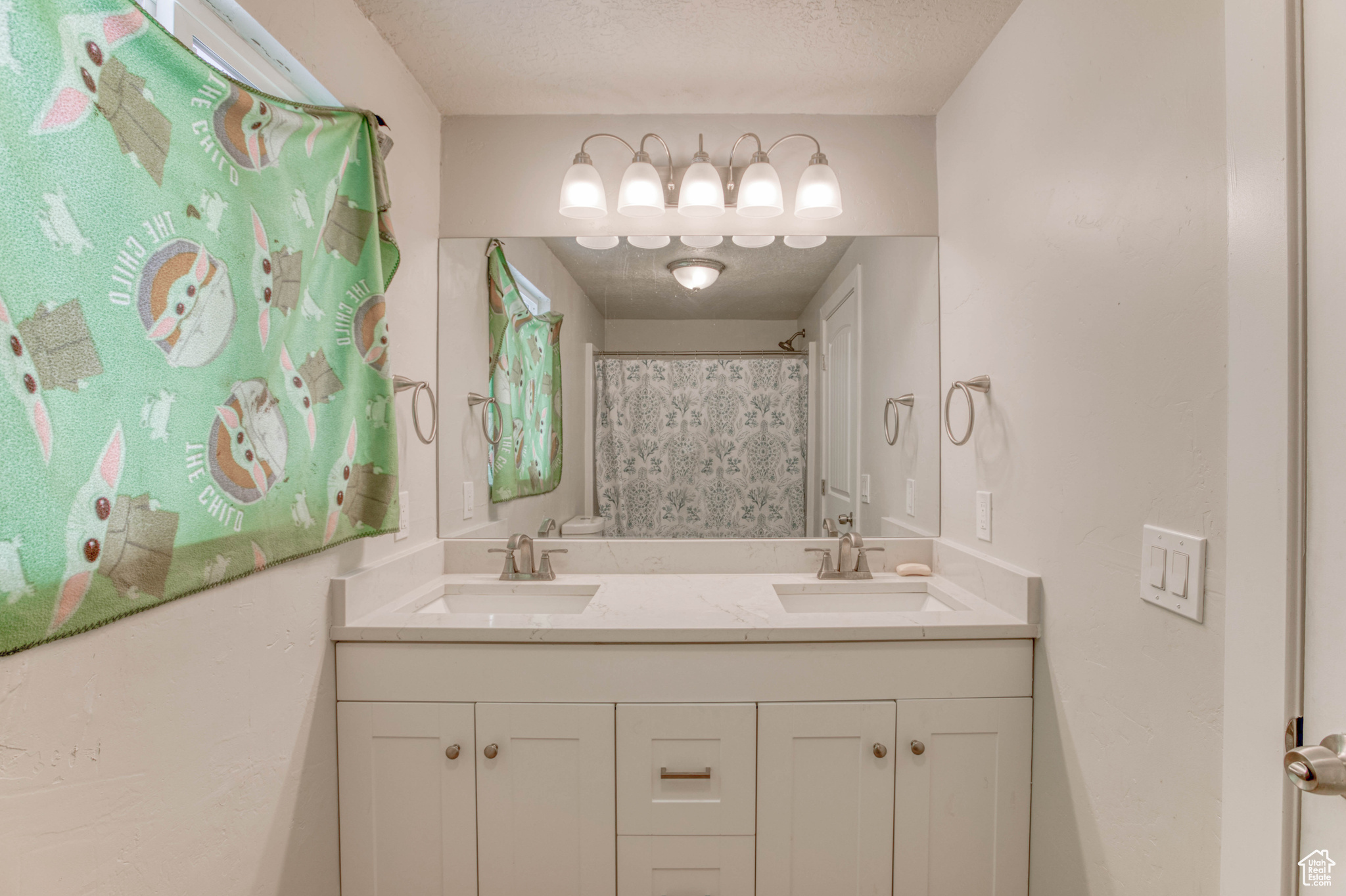 Bathroom featuring vanity, a textured ceiling, and a shower with shower curtain