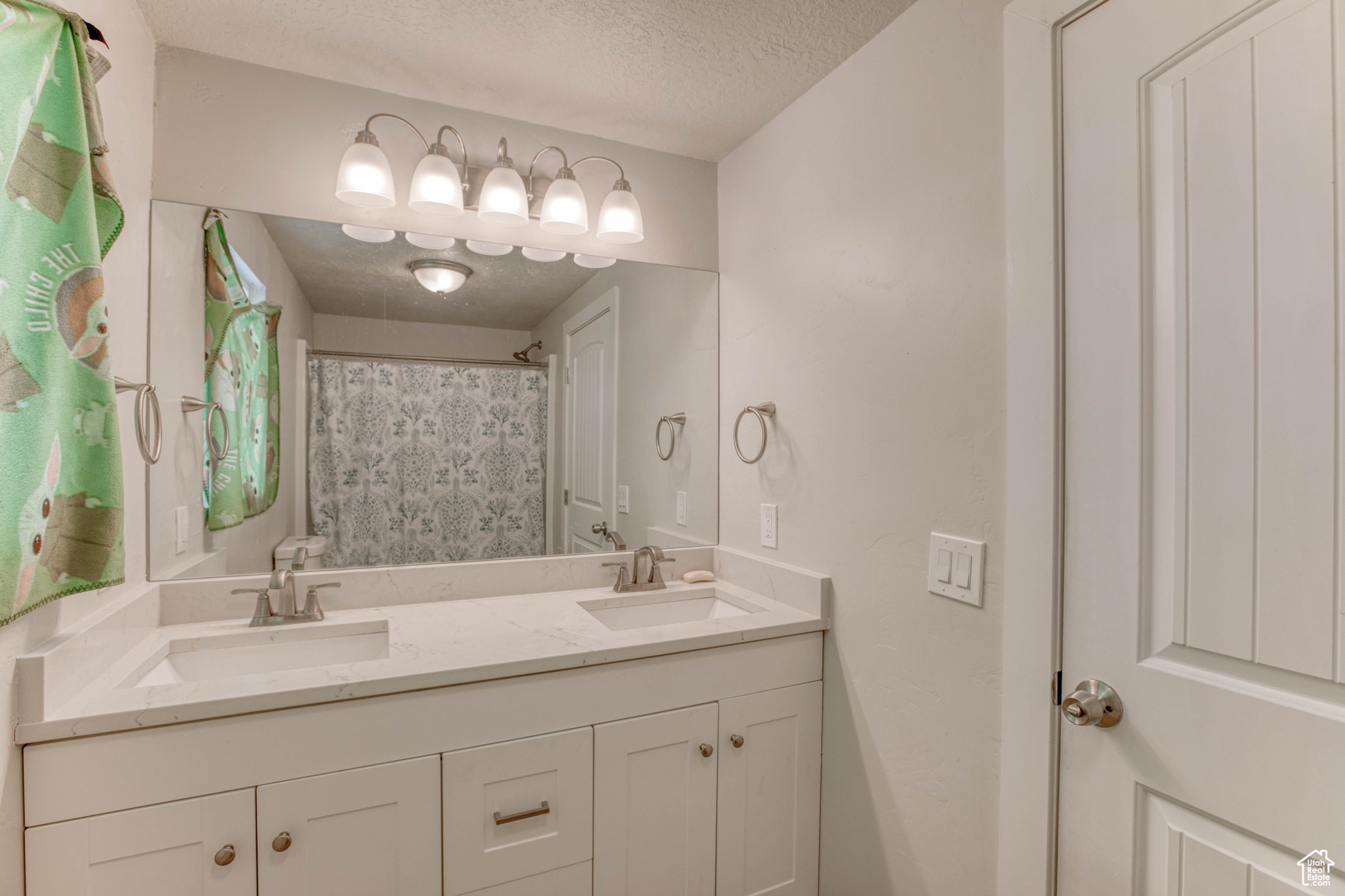 Bathroom featuring vanity and a textured ceiling