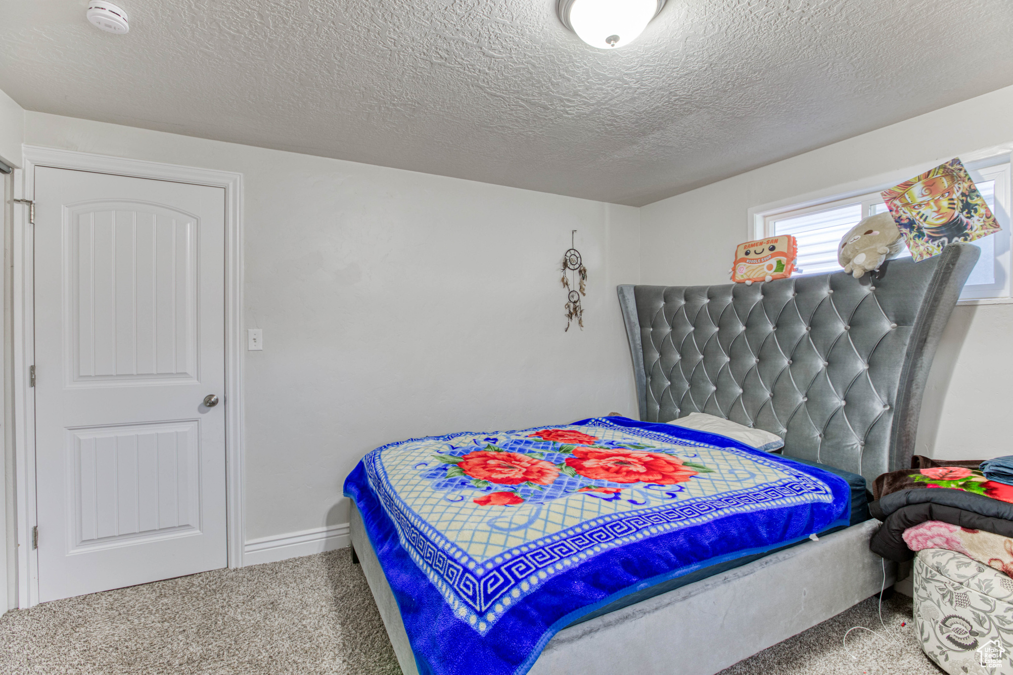 Bedroom with carpet flooring and a textured ceiling