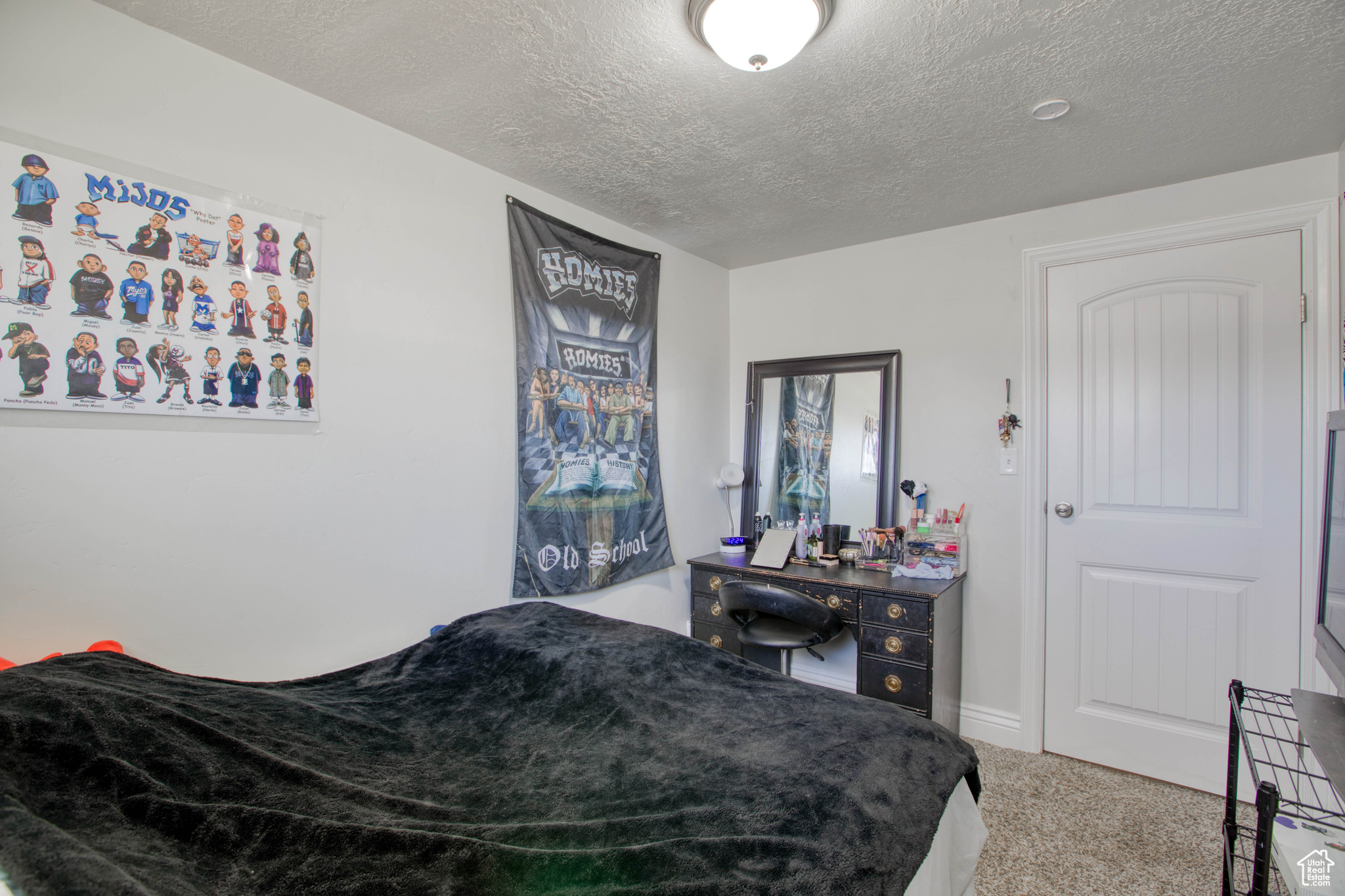 Bedroom featuring carpet and a textured ceiling