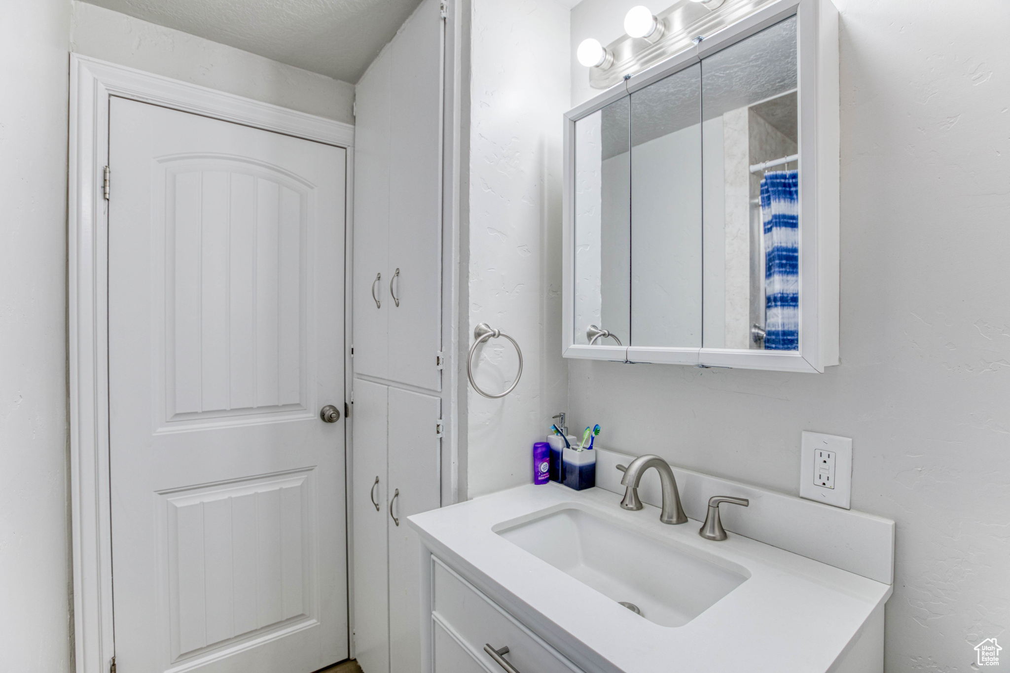 Bathroom featuring vanity and a textured ceiling