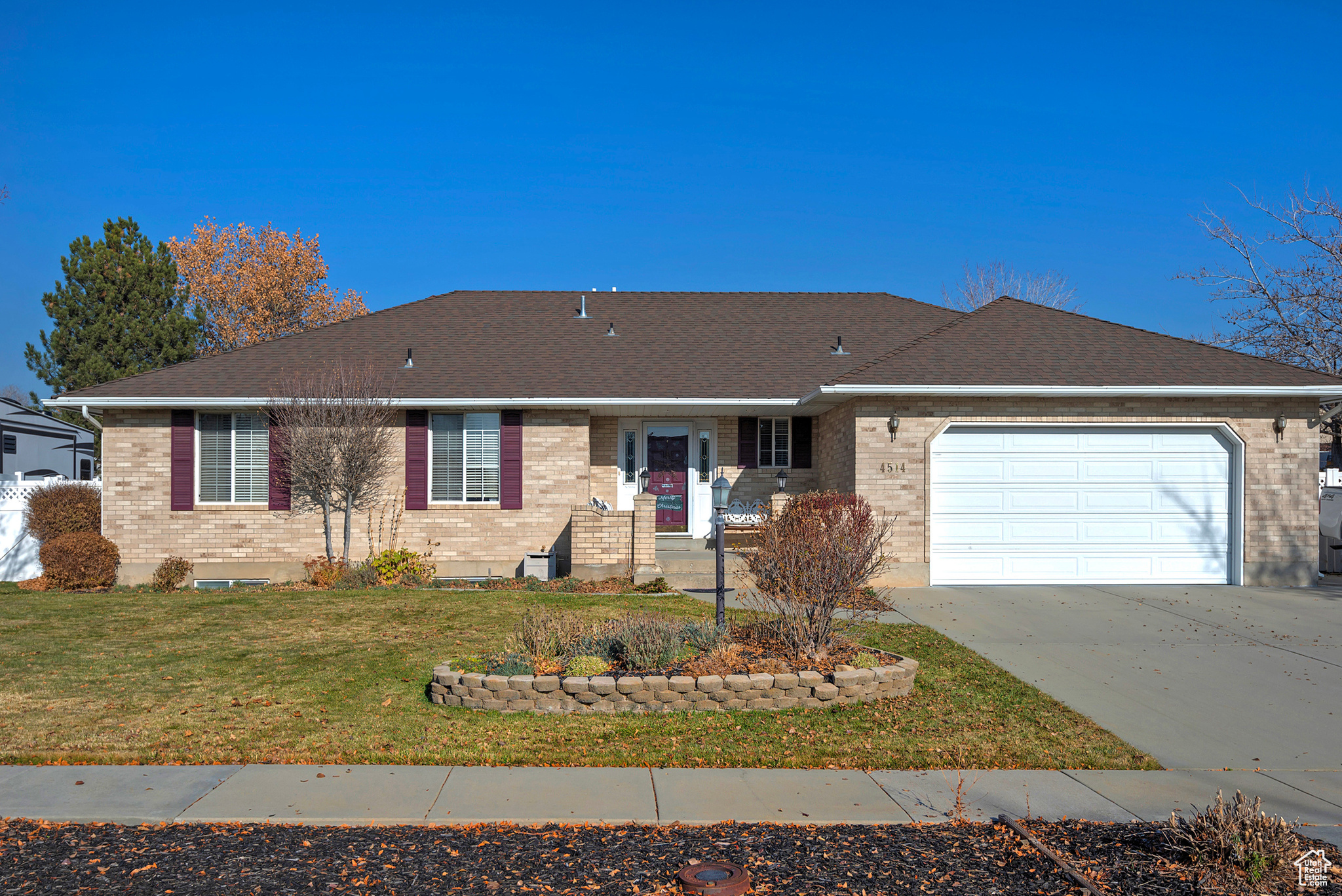 Ranch-style house with a front yard and a garage